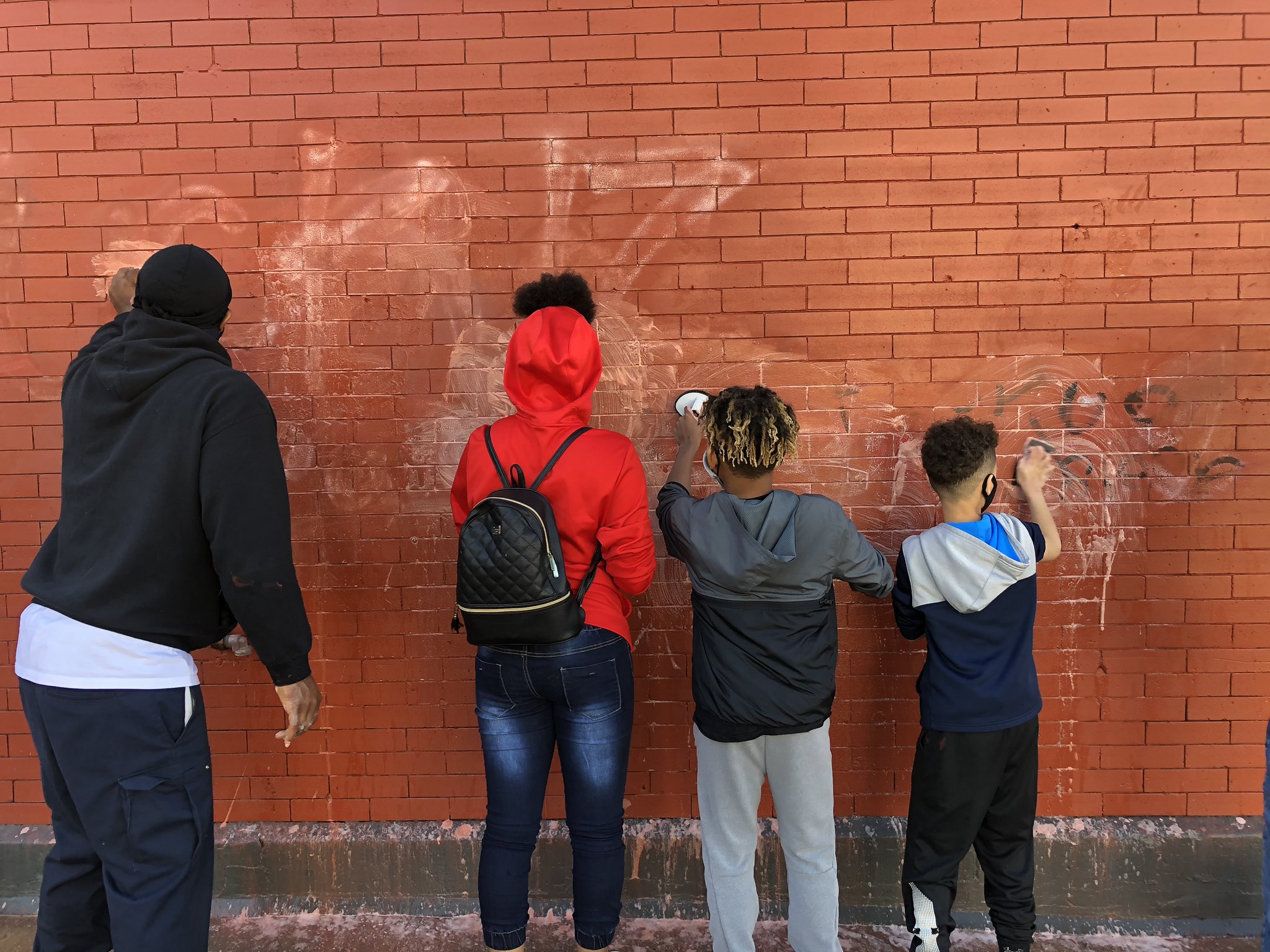 family works to clean up graffiti