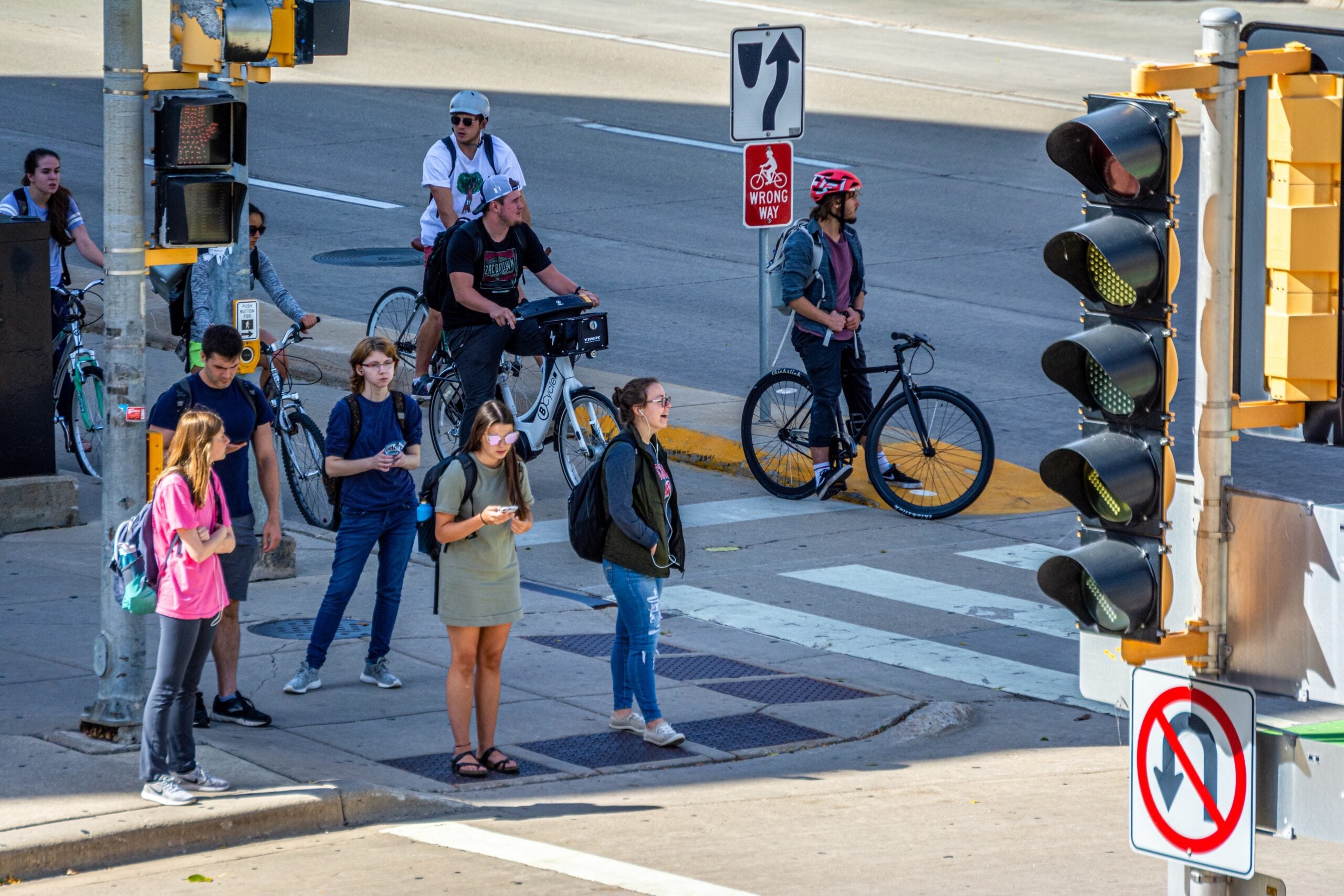 Students along University Ave. waiting to cross Park St. on the University of Wisconsin-Madison campus.