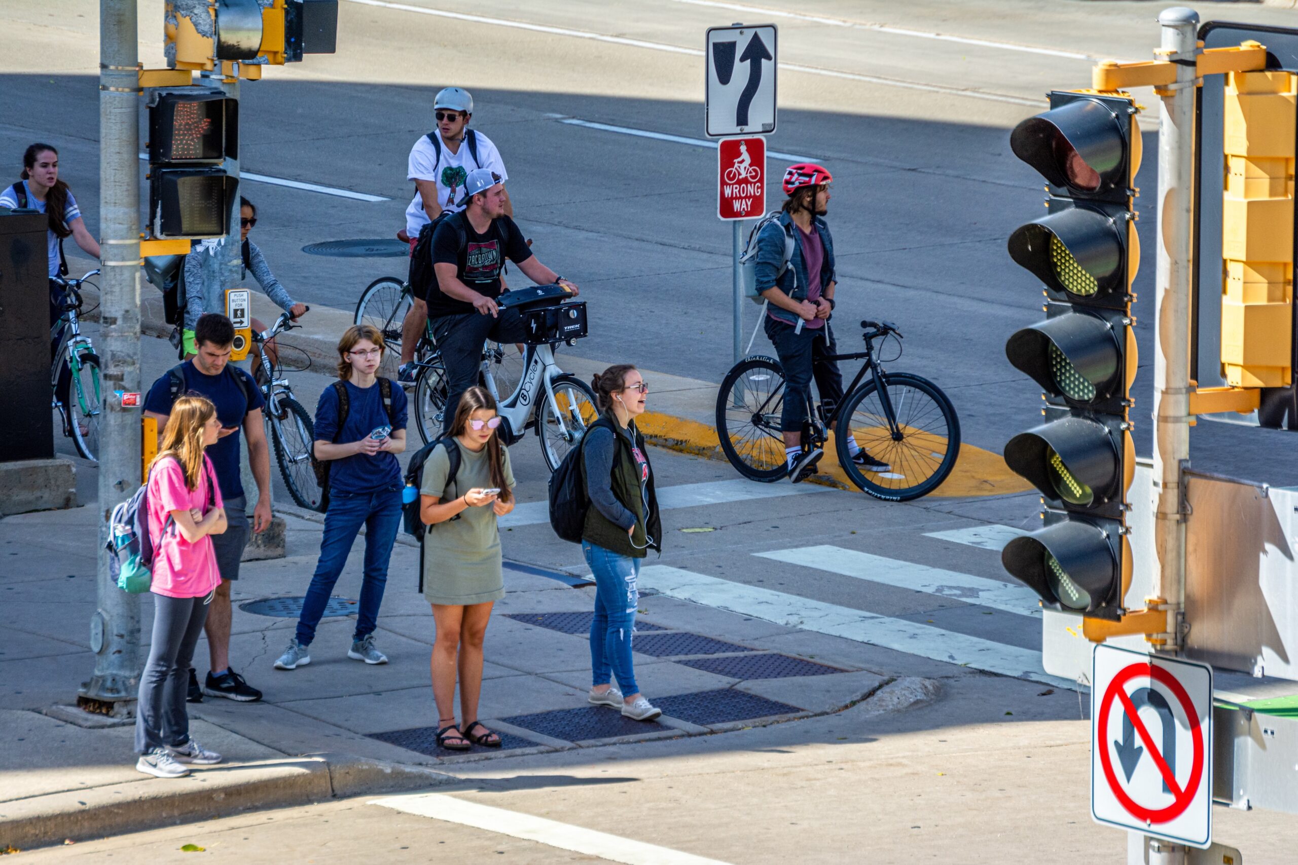 Students along University Ave. waiting to cross Park St. on the University of Wisconsin-Madison campus.