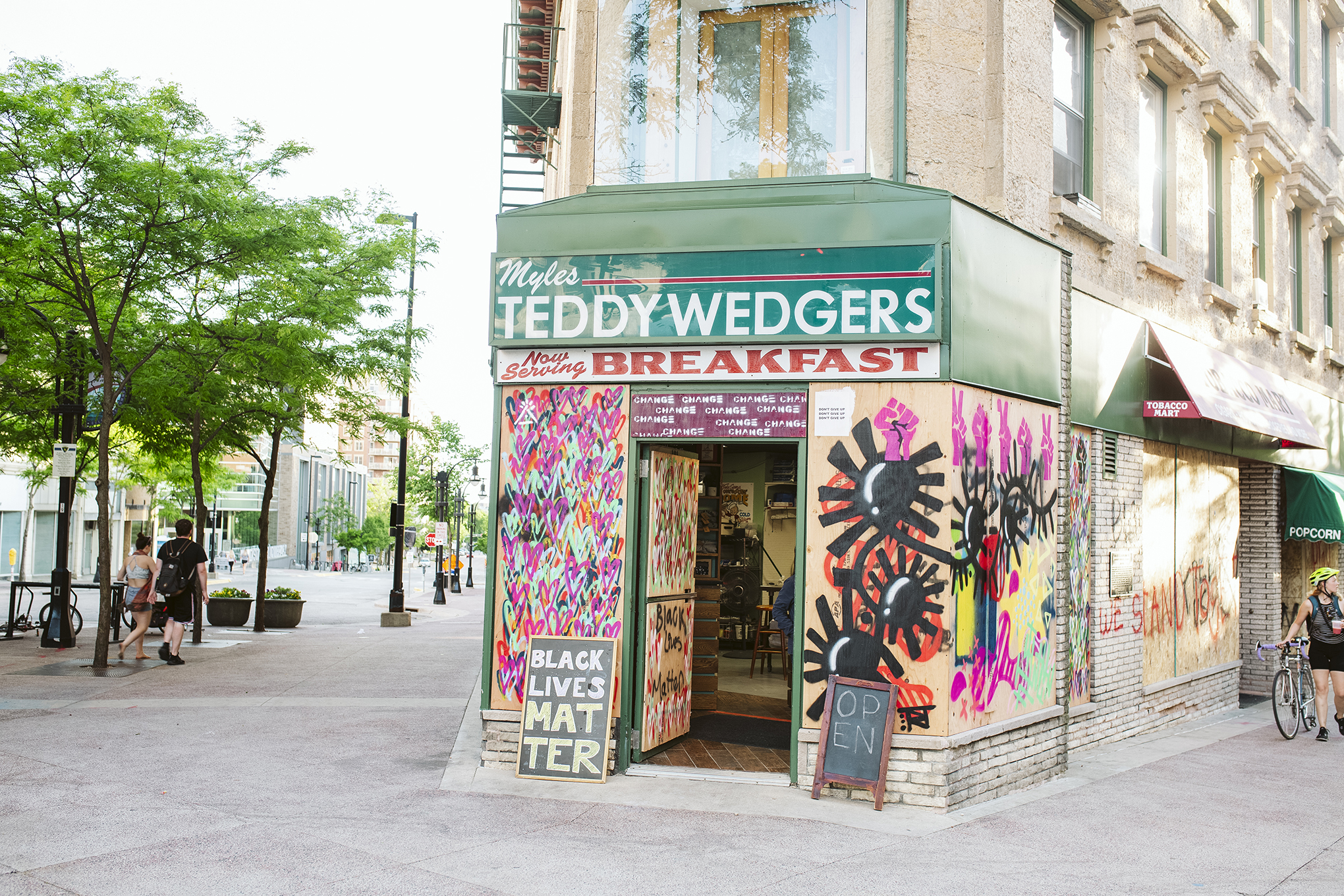 Triangulador's artwork is displayed on boarded up store windows on State Street