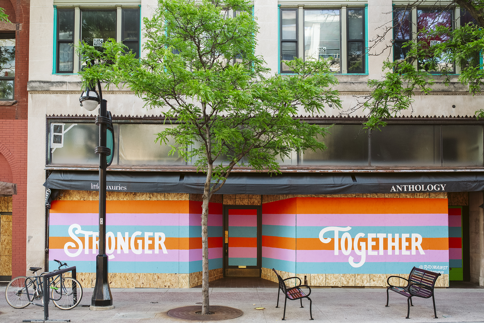 Artwork is displayed on boarded up store windows on State Street in downtown Madison