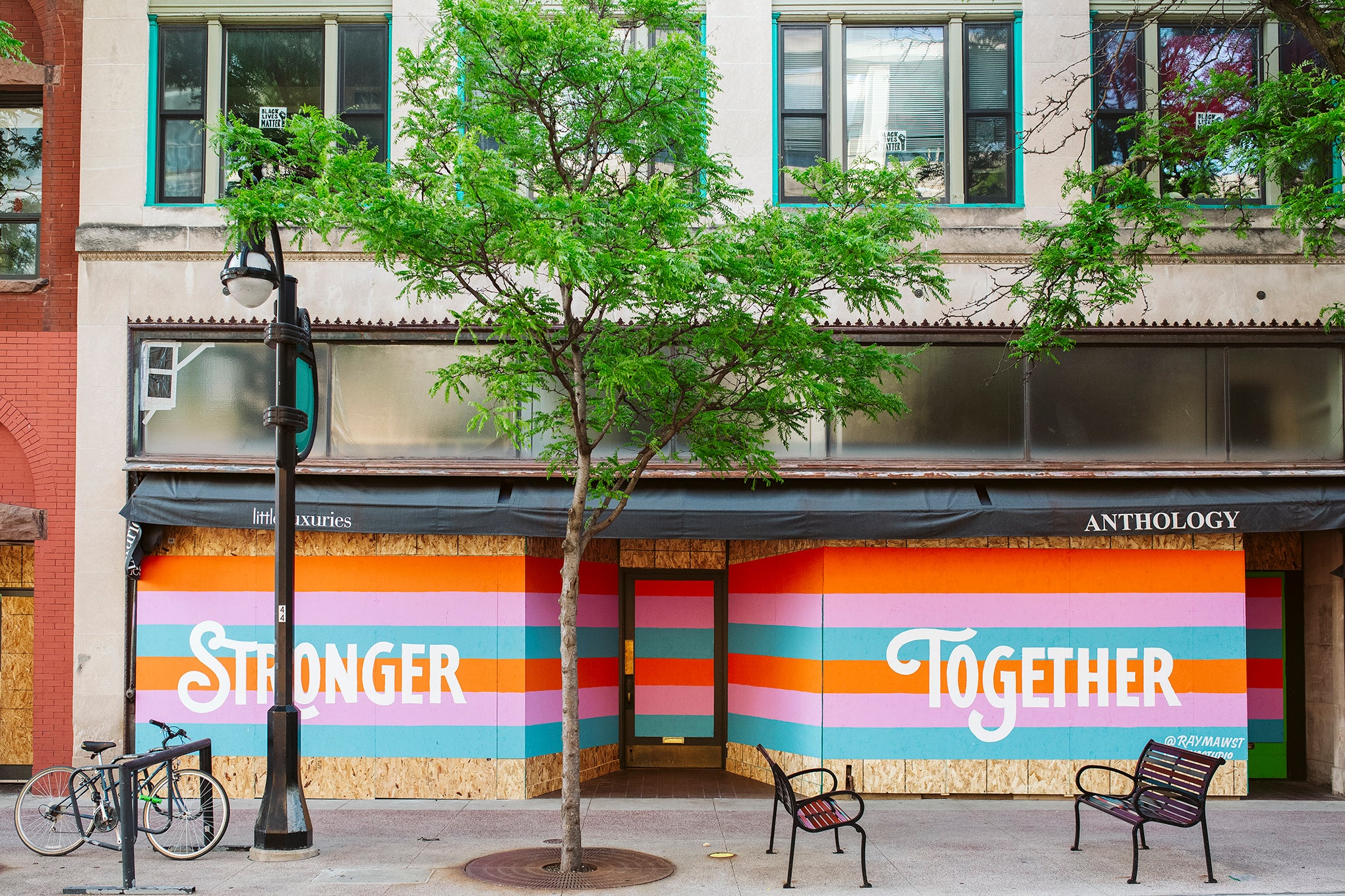 Artwork is displayed on boarded up store windows on State Street in downtown Madison