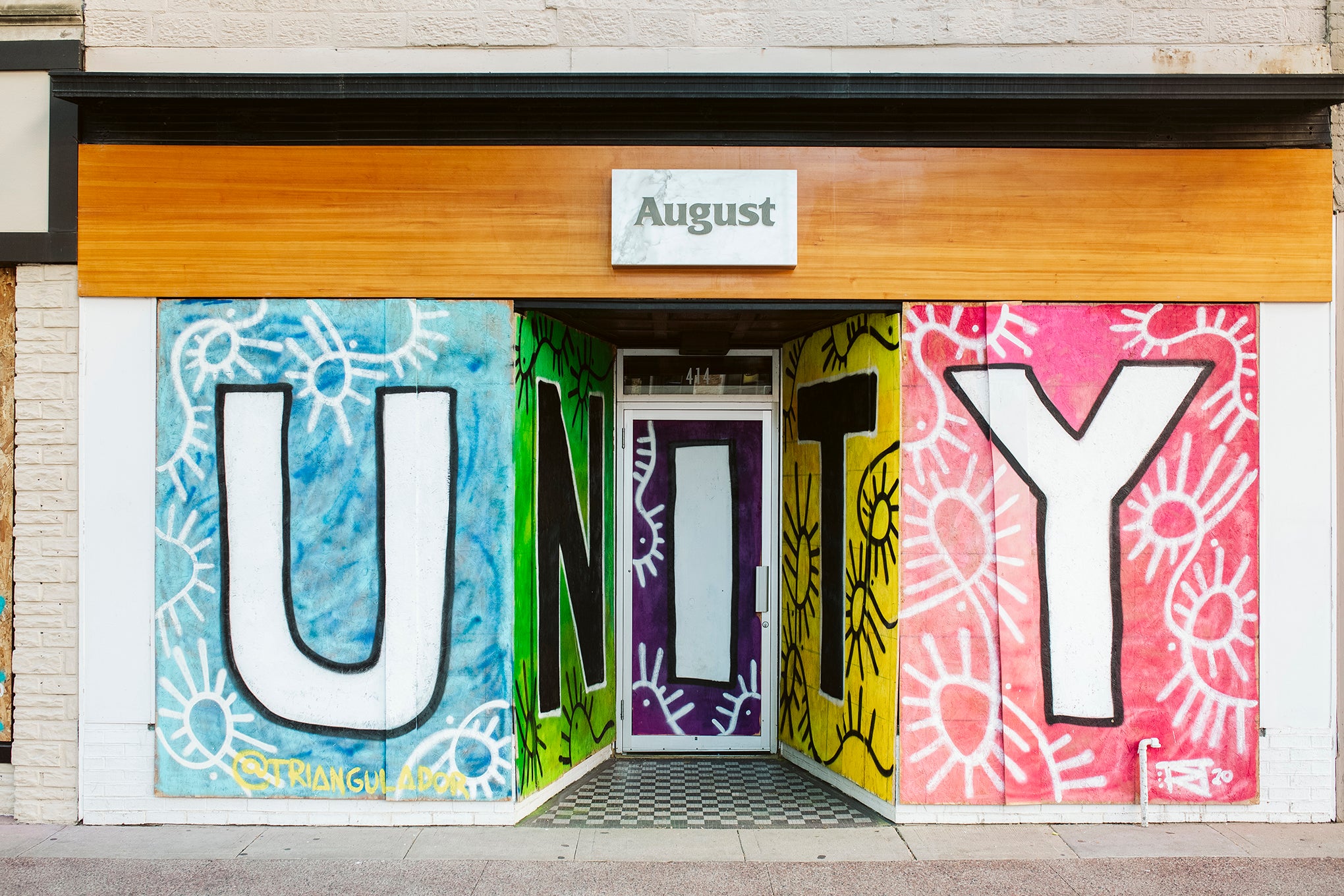 Artwork is displayed on boarded up store windows on State Street in downtown Madison