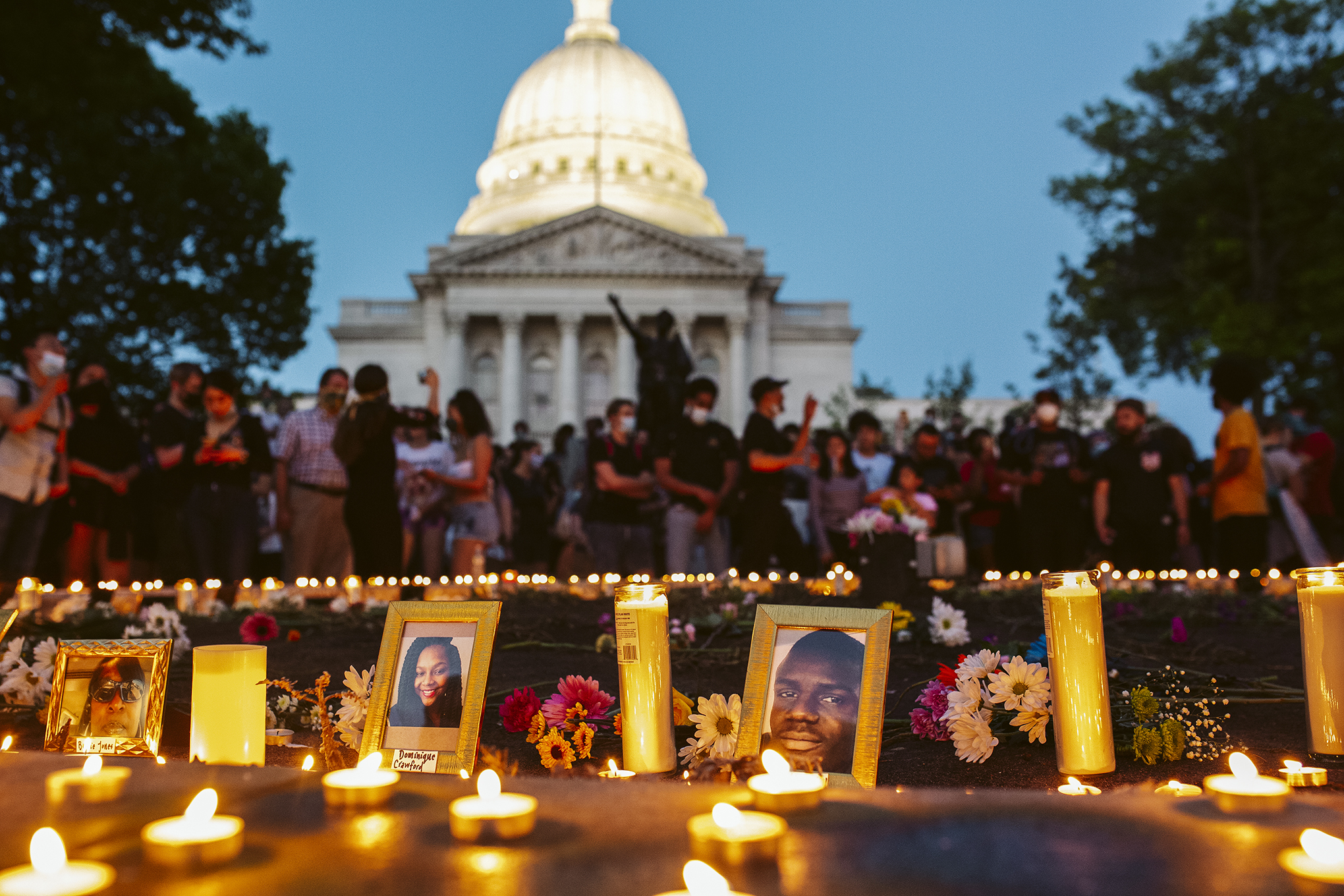 Photos and candles honor black people killed by police