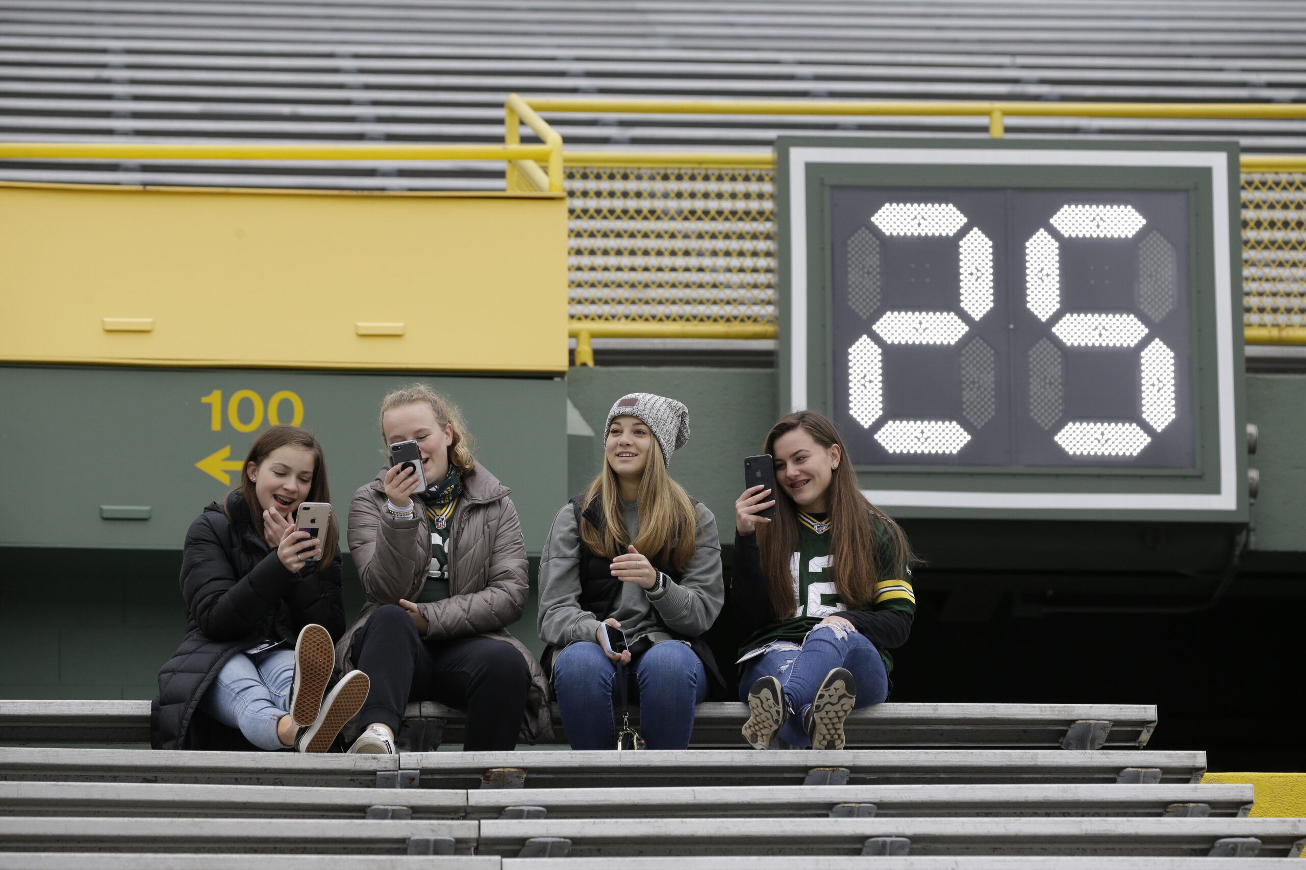 Fans sit in the stands at Lambeau Field