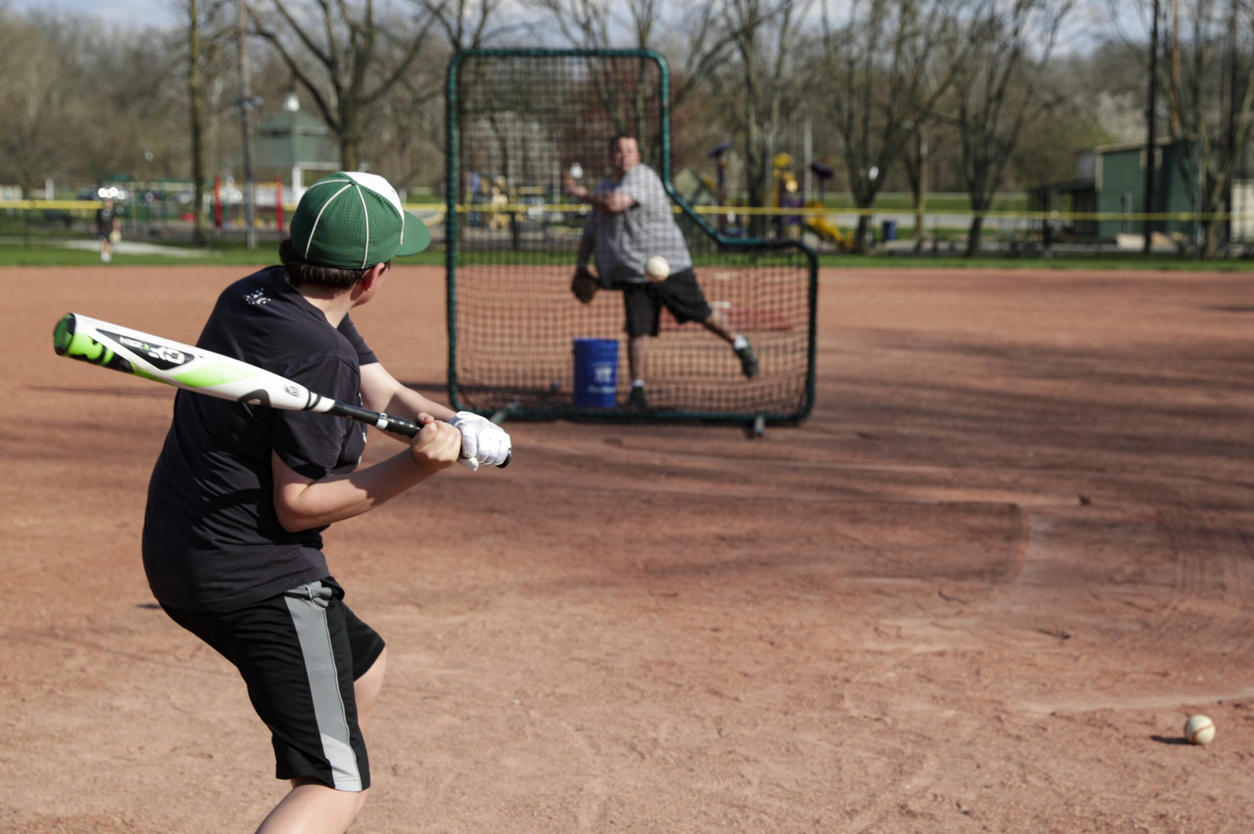 A father and son take batting practice during the coronavirus pandemic