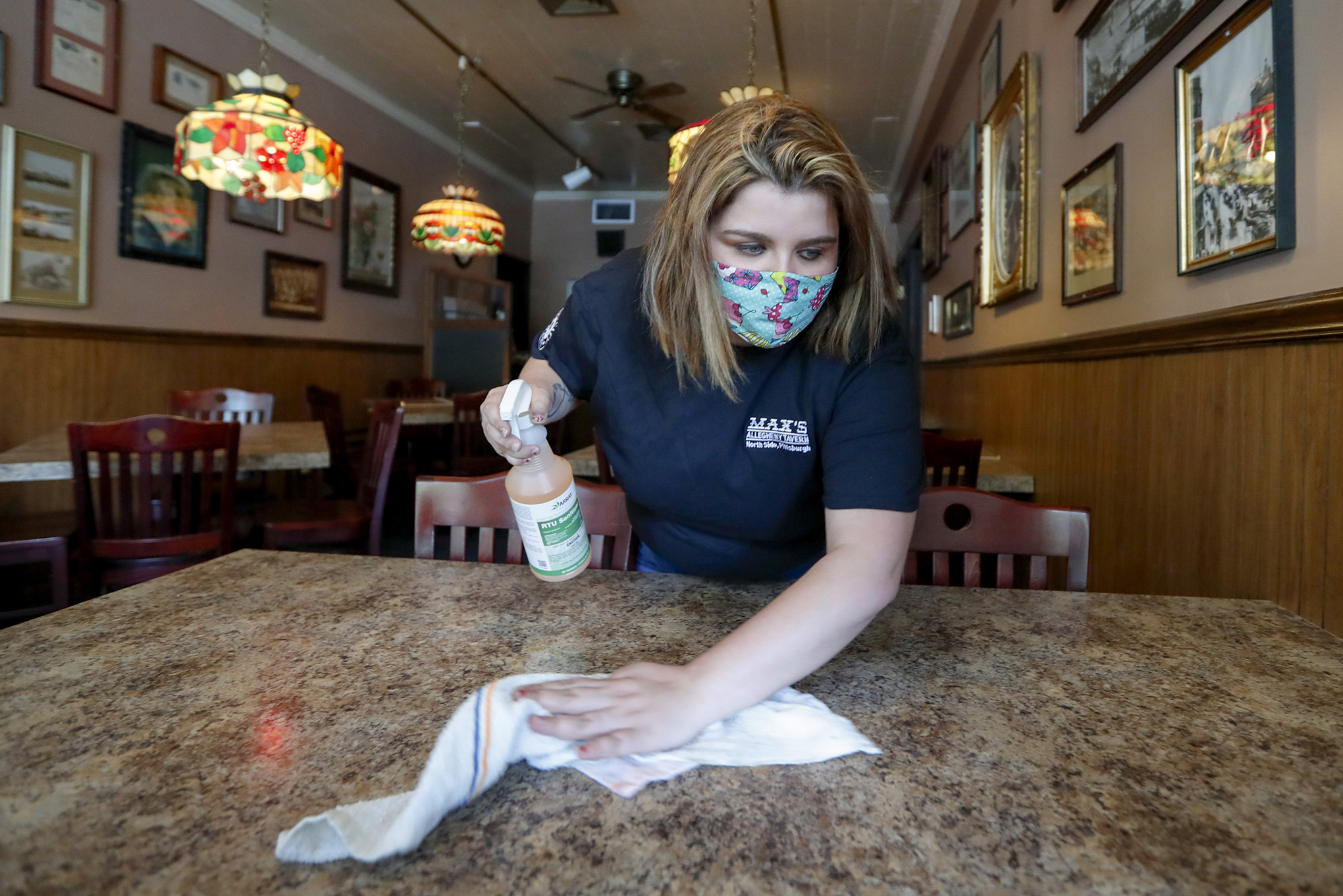 Sara Kennely, cleans one of the dining tables at Max's Allegheny Tavern