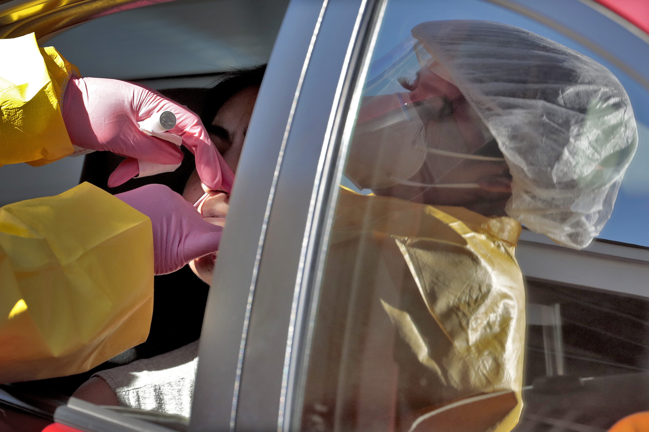 People get tested for COVID-19 at a drive through testing site