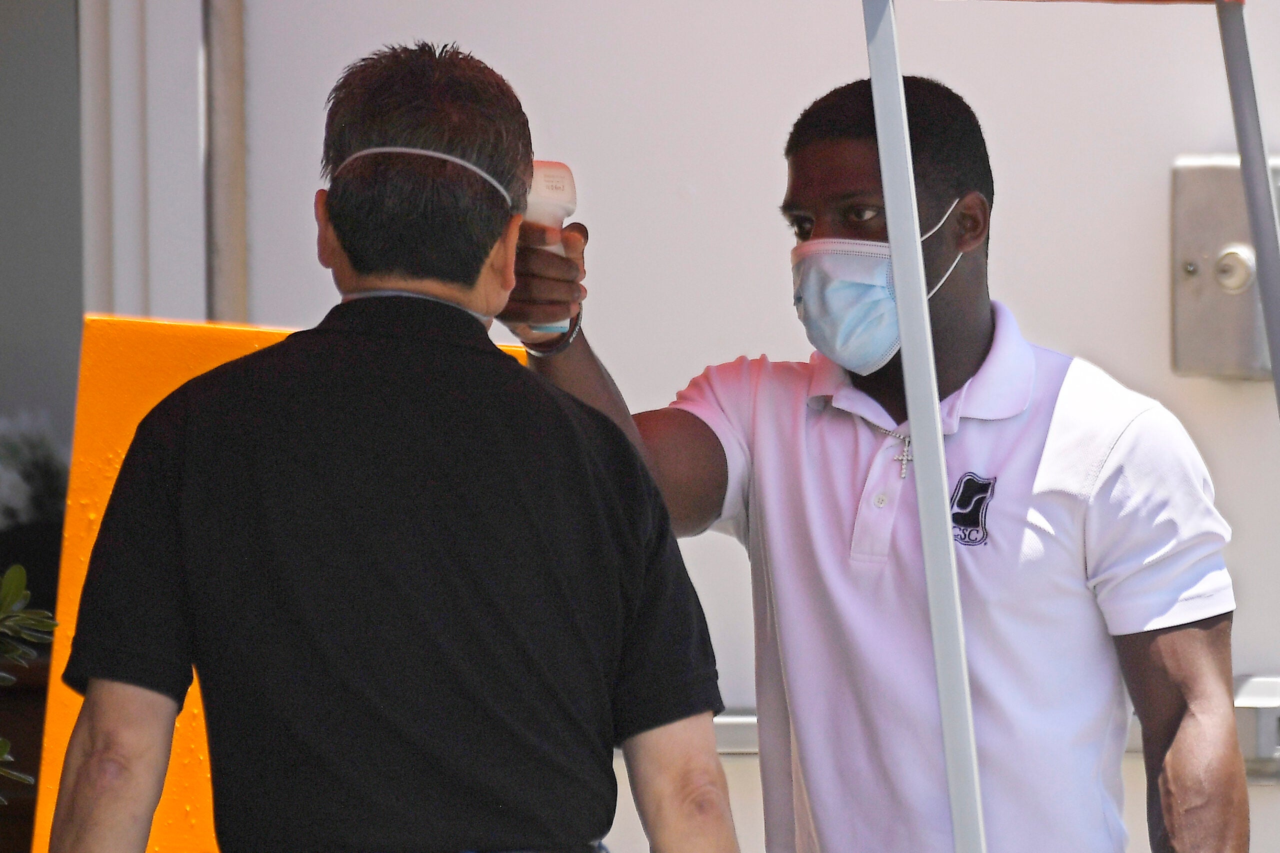 A man has his temperature checked