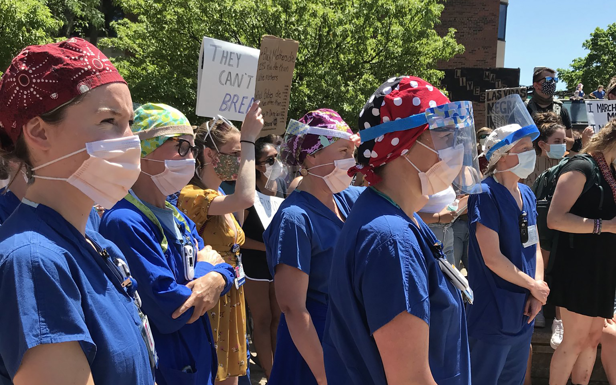 UnityPoint-Meriter staff, all wearing PPE, listen to speeches during a Black Lives Matter protest