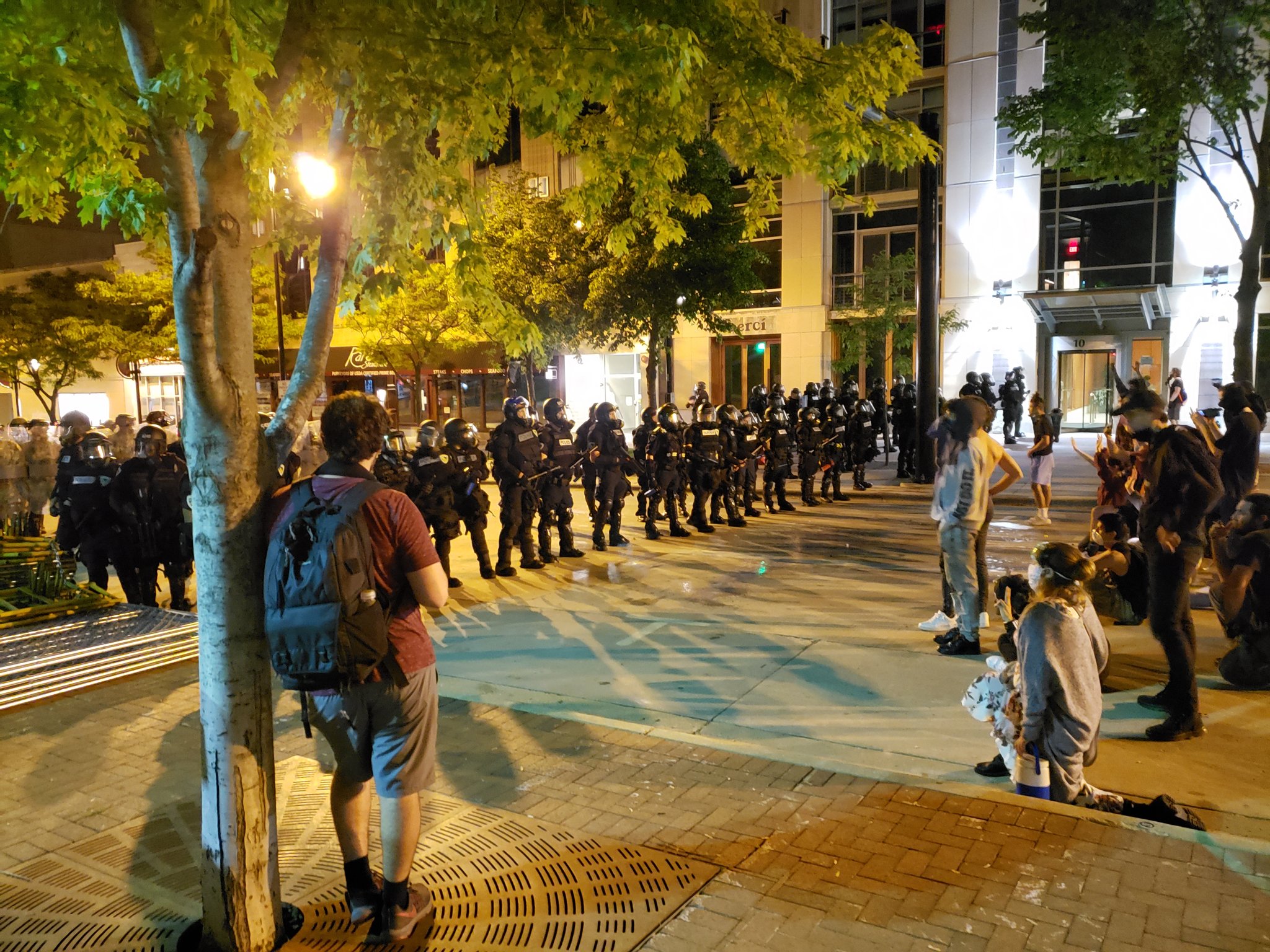 Police face off against protesters in downtown Madison on Sunday night.