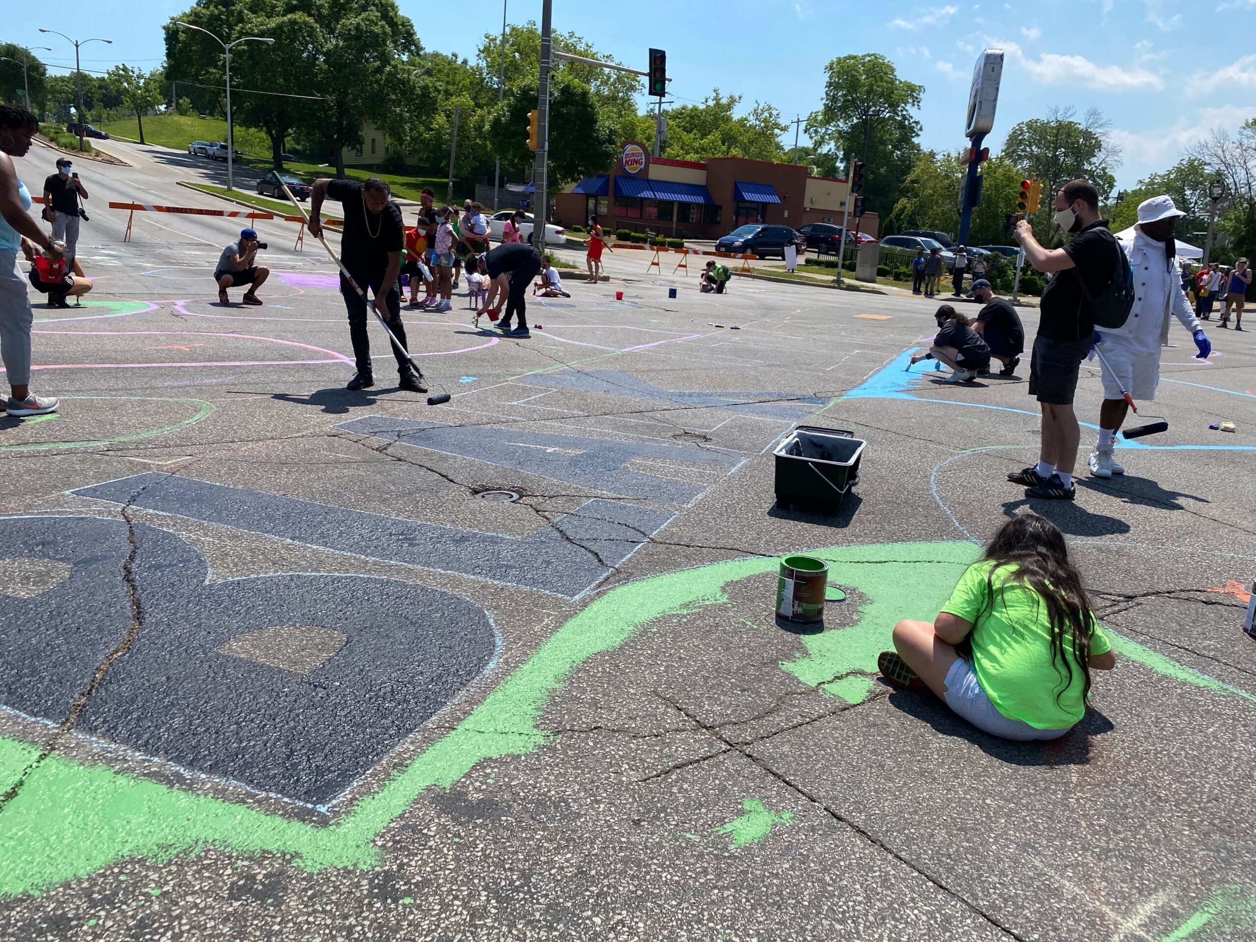 Community members help paint a 