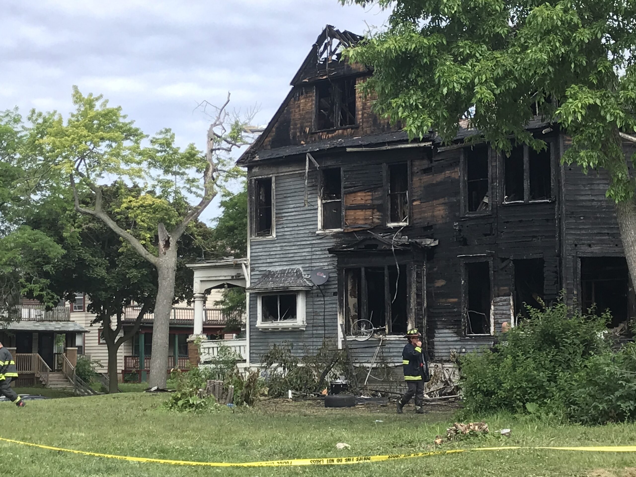 Milwaukee Fire Department inspectors examine a house that was set on fire during protests over missing girls on Milwaukee's west side.