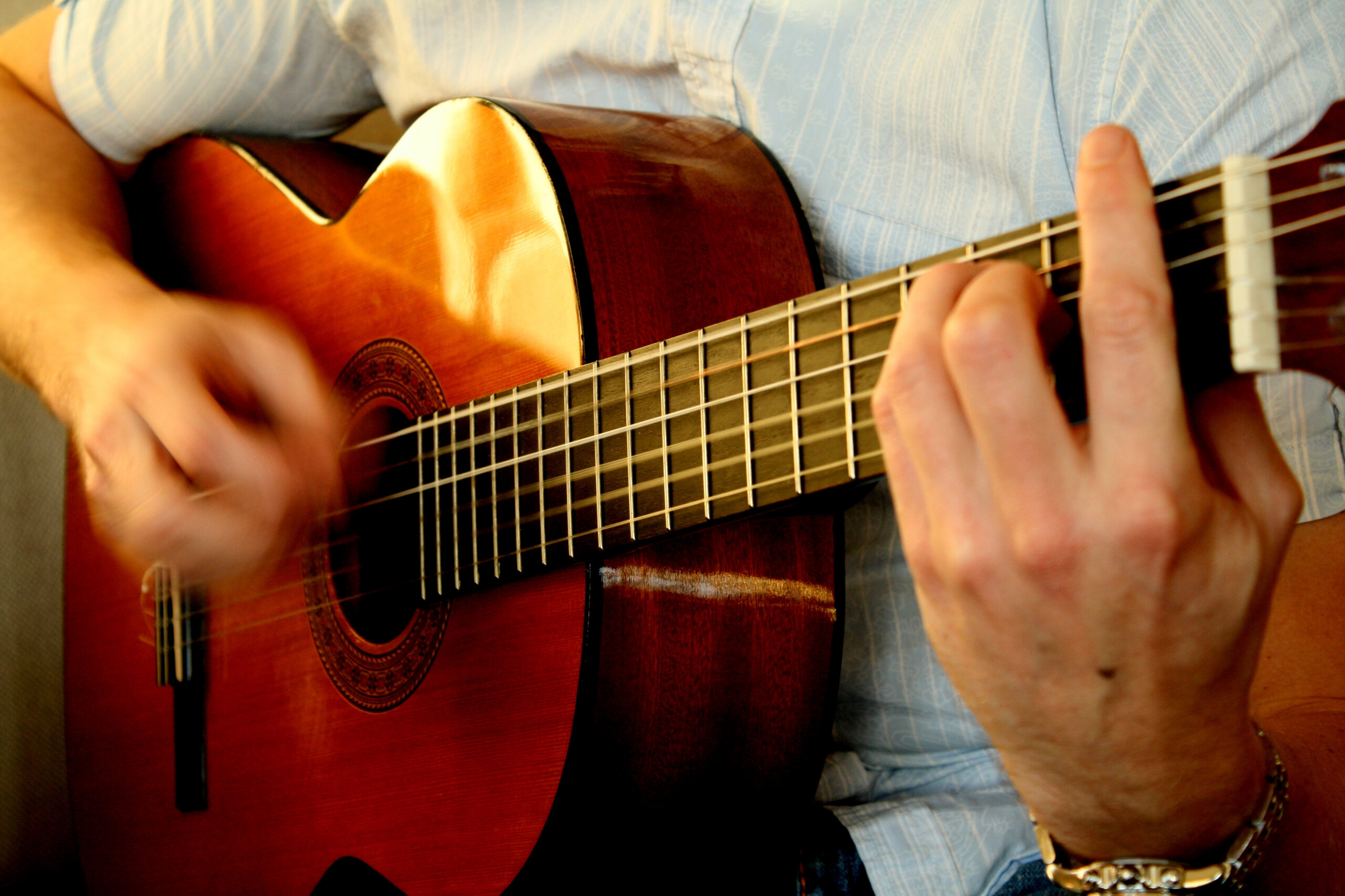 Person playing acoustic guitar