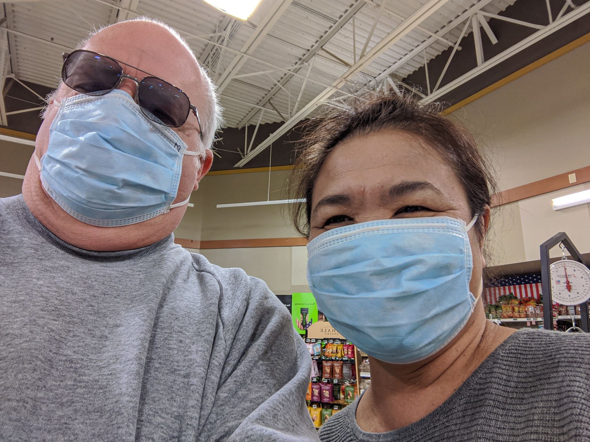 Two people shopping with masks on.