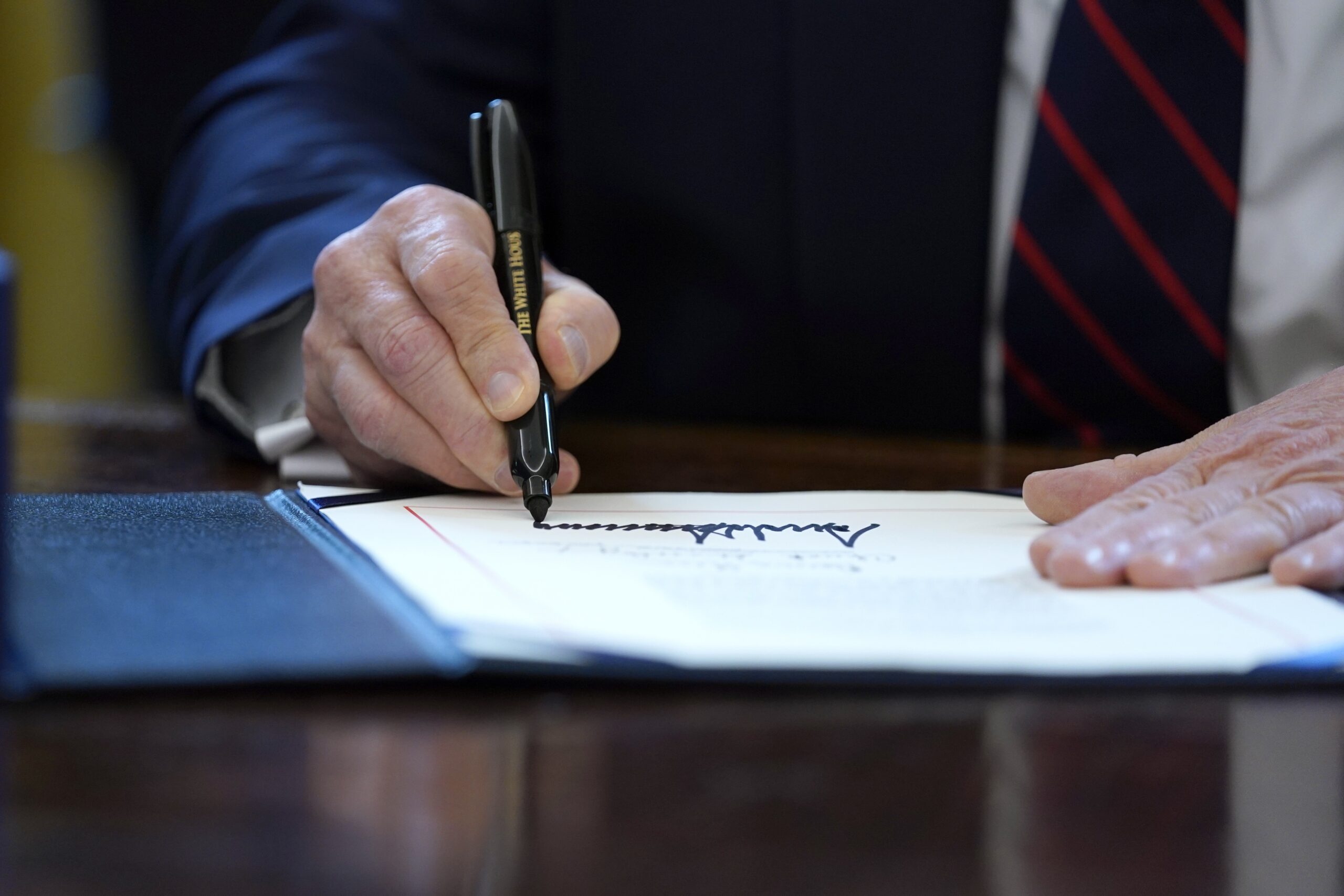 President Donald Trump signs coronavirus stimulus bill