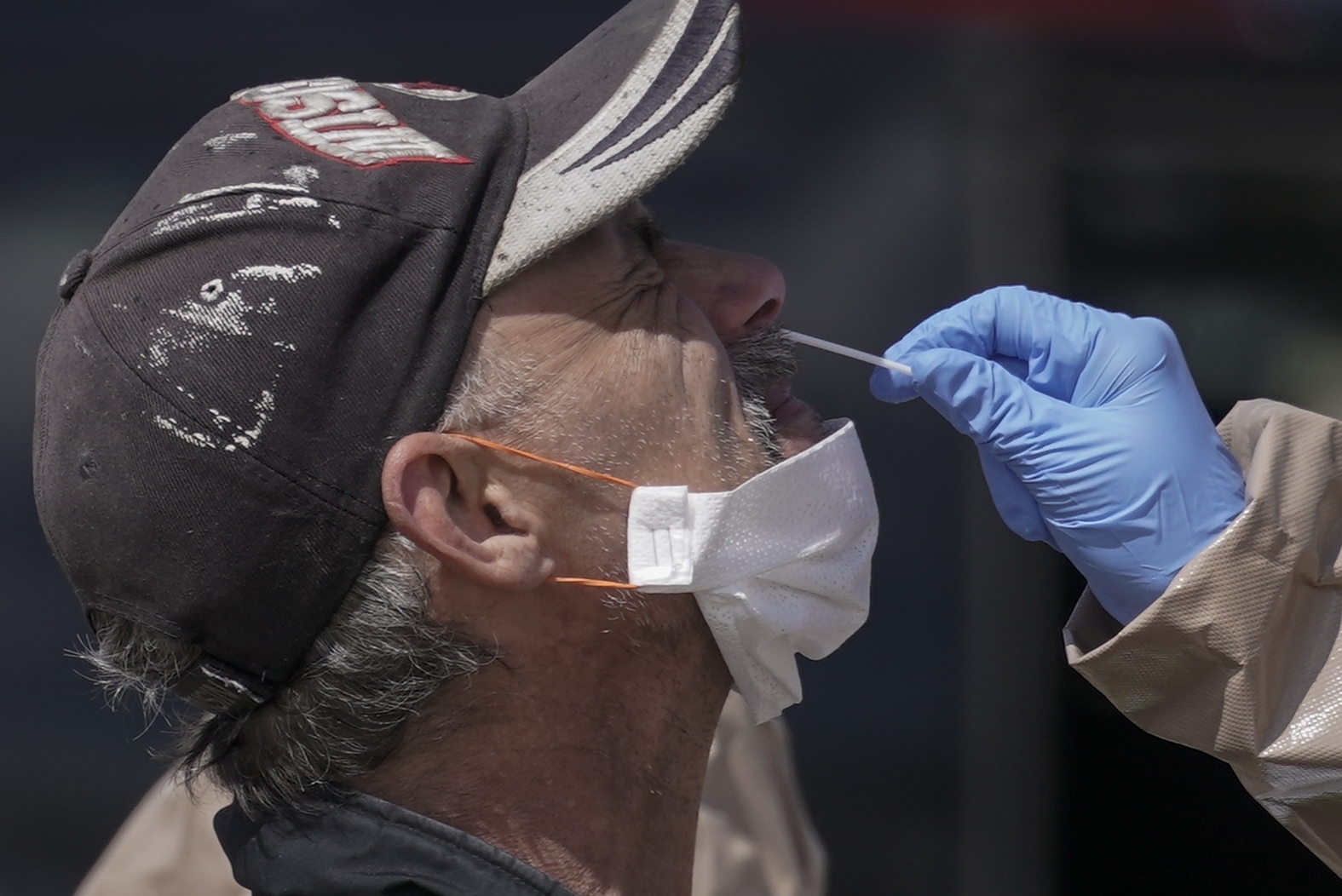 Wisconsin National Guard members administer COVID-19 tests in a parking lot