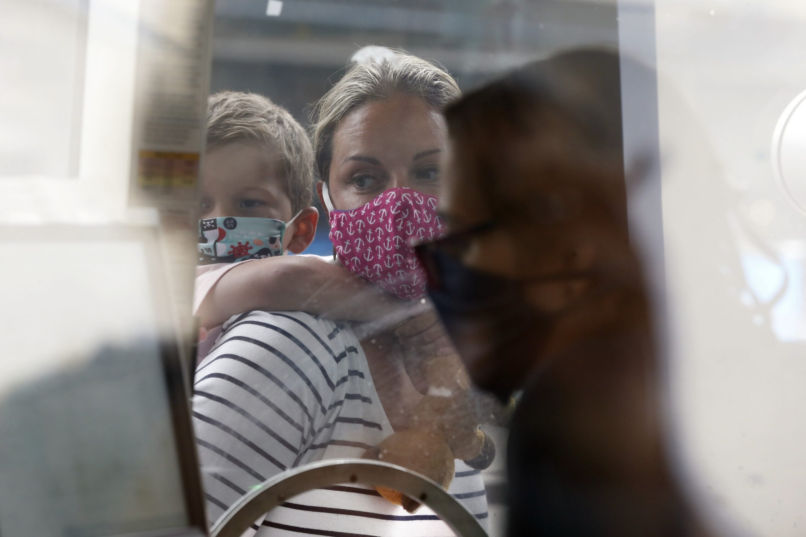 A woman wears a face mask at a Boston aquarium