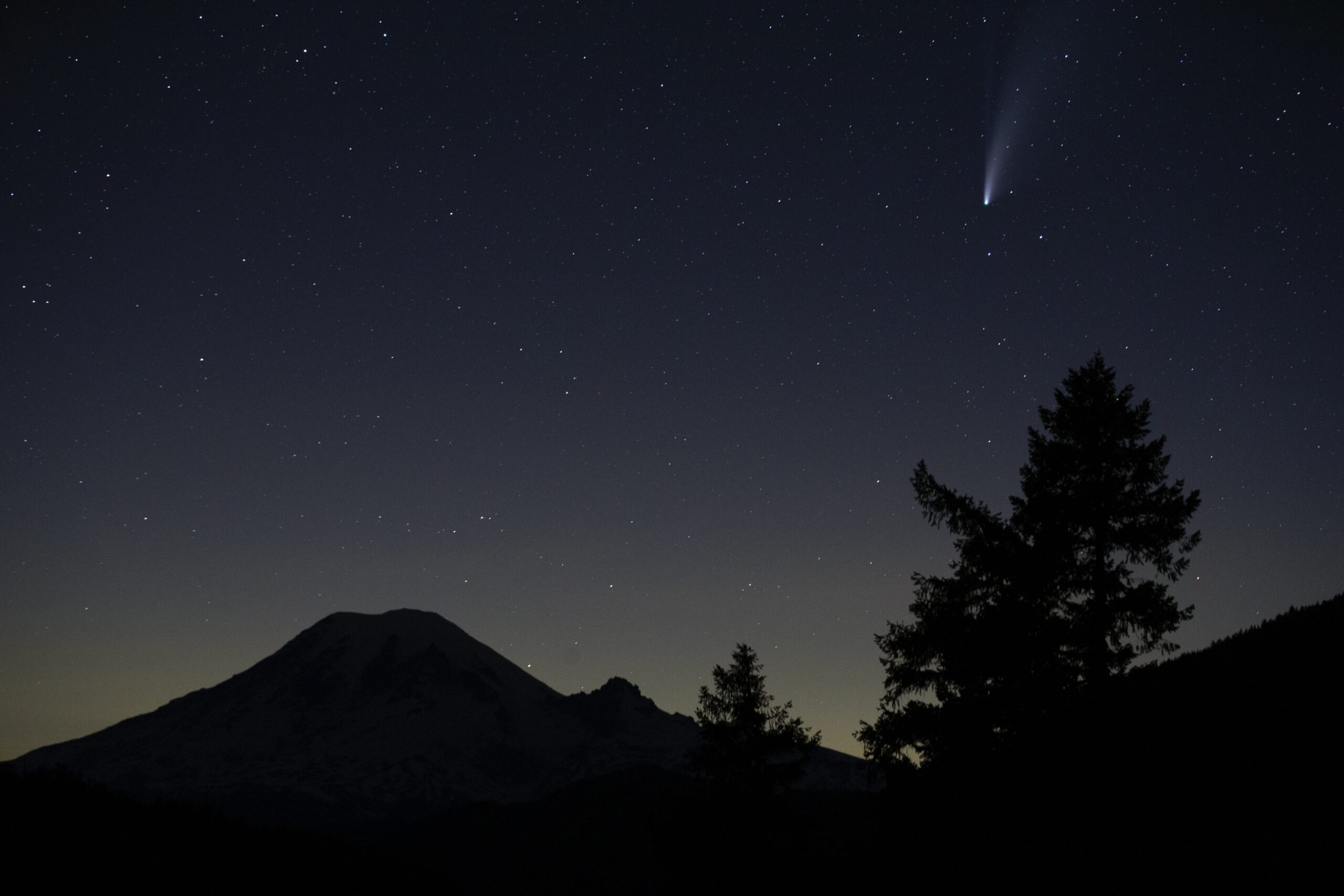 The Comet Neowise appears in the night sky above Mount Rainier, Saturday, July 18, 2020, near Packwood, Wash
