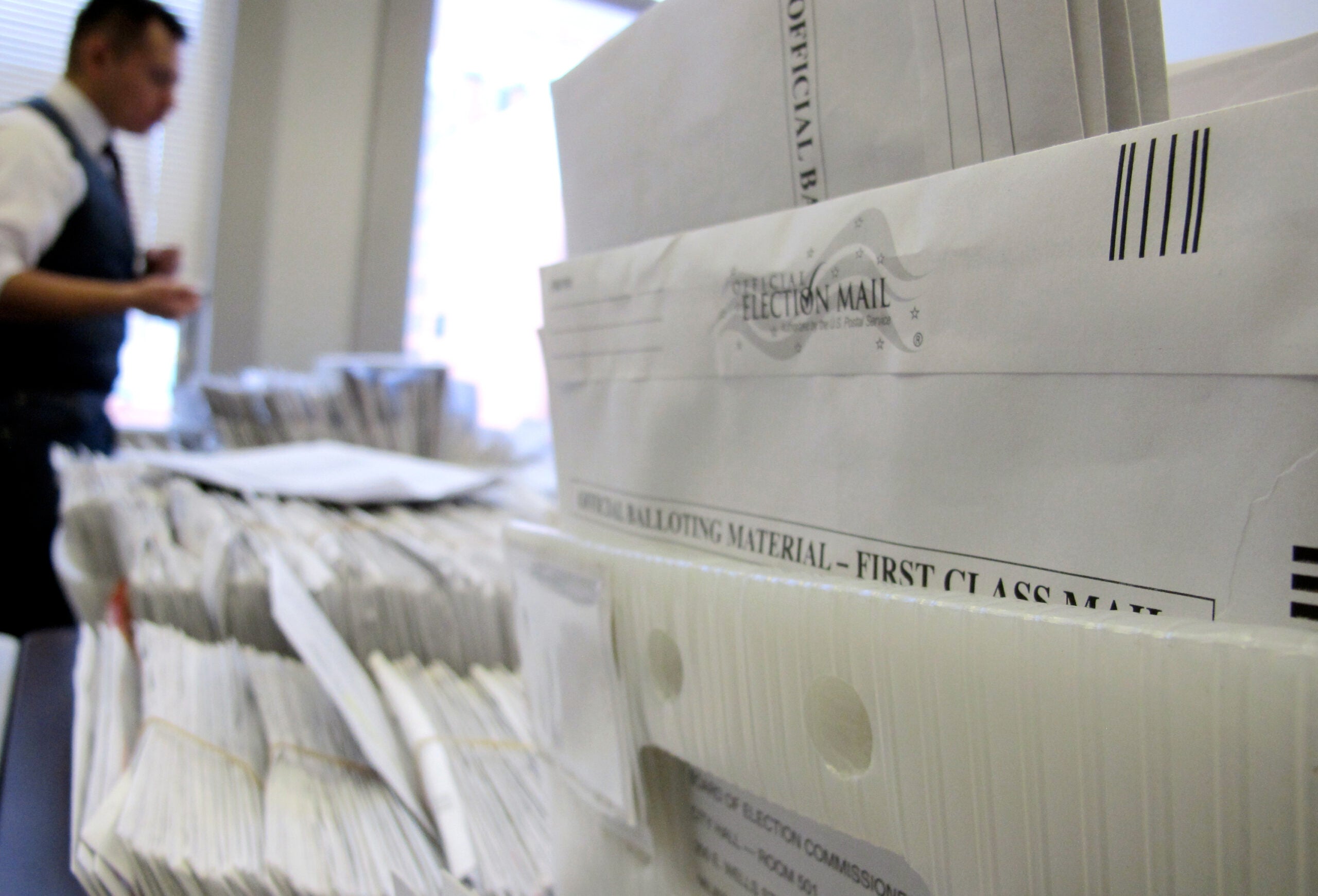Staffer sorting absentee ballots