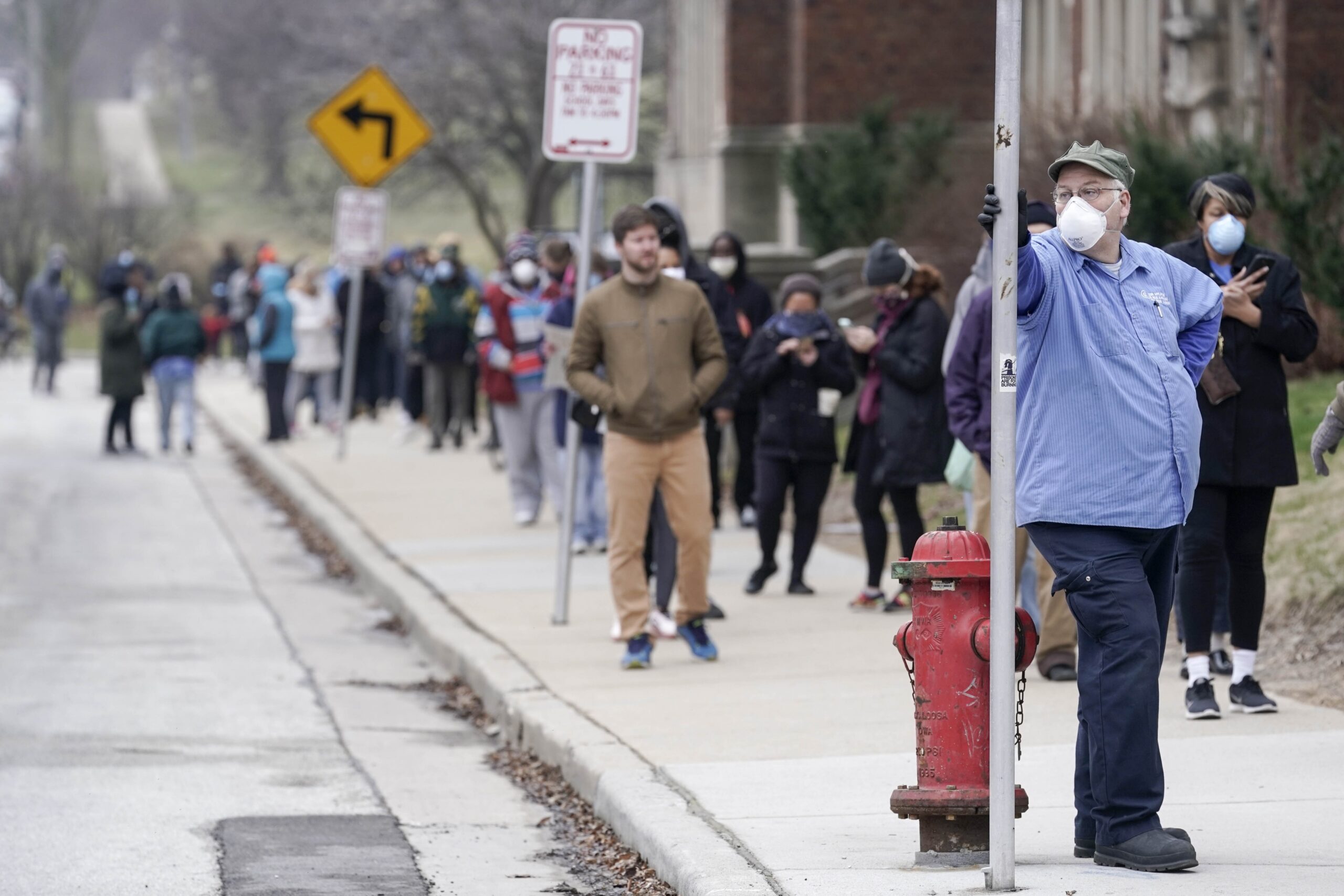 Voters masked against coronavirus line up at Riverside High School for Wisconsin's primary election