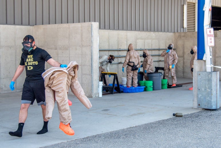 Public Health Madison and Dane County employees and Wisconsin National Guard members operate a drive-through COVID-19 testing facility