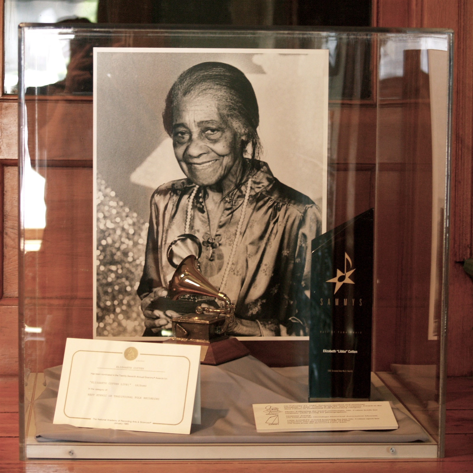 Photo of Elizabeth Cotten with her 1984 Grammy & 1996 Syracuse Area Music Award (Erie Canal Museum: Syracuse, NY)