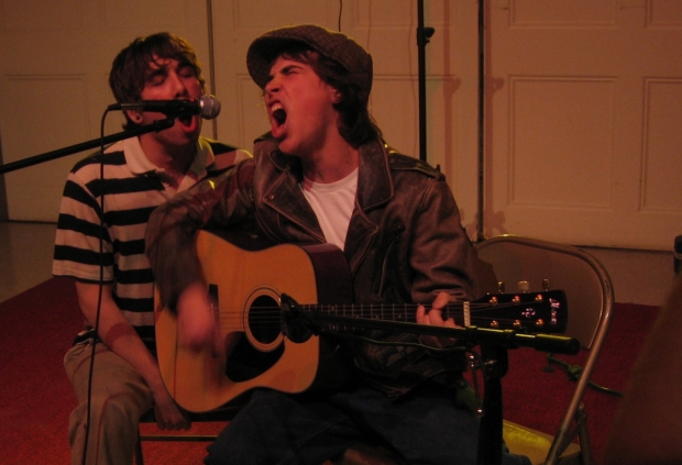 Two young men singing together