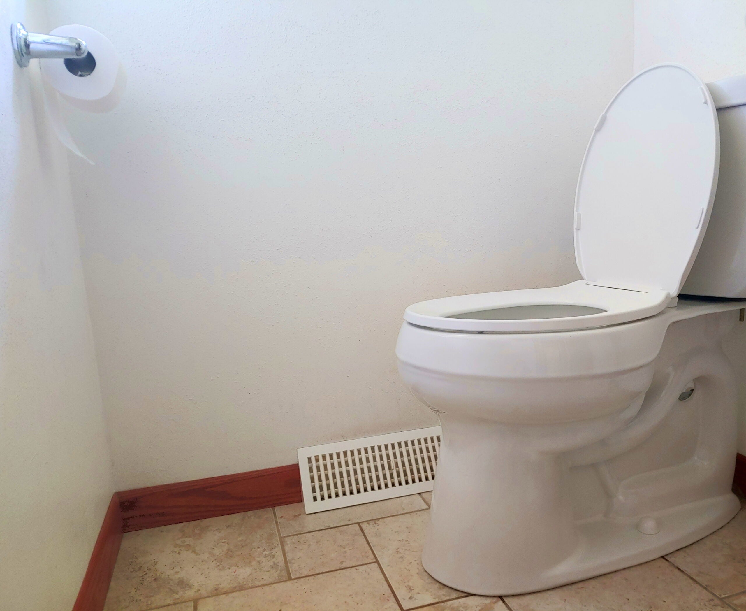 A toilet in a bathroom