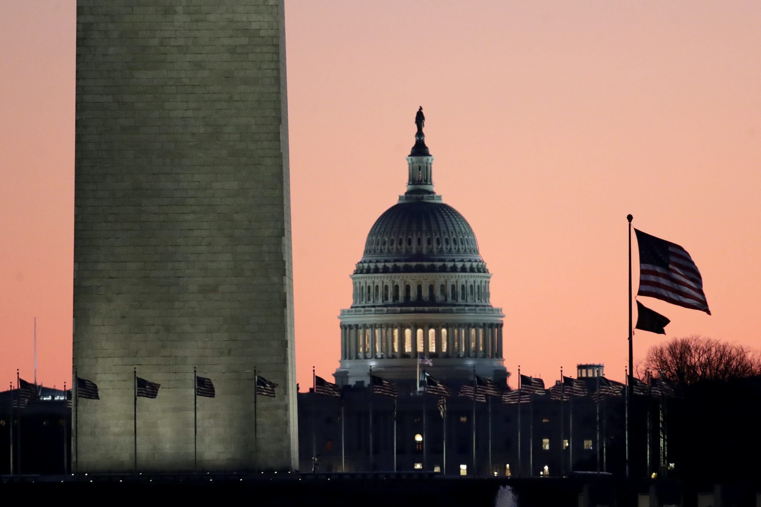 The U.S. Capitol building is seen next to the bottom part of the Washington Monument