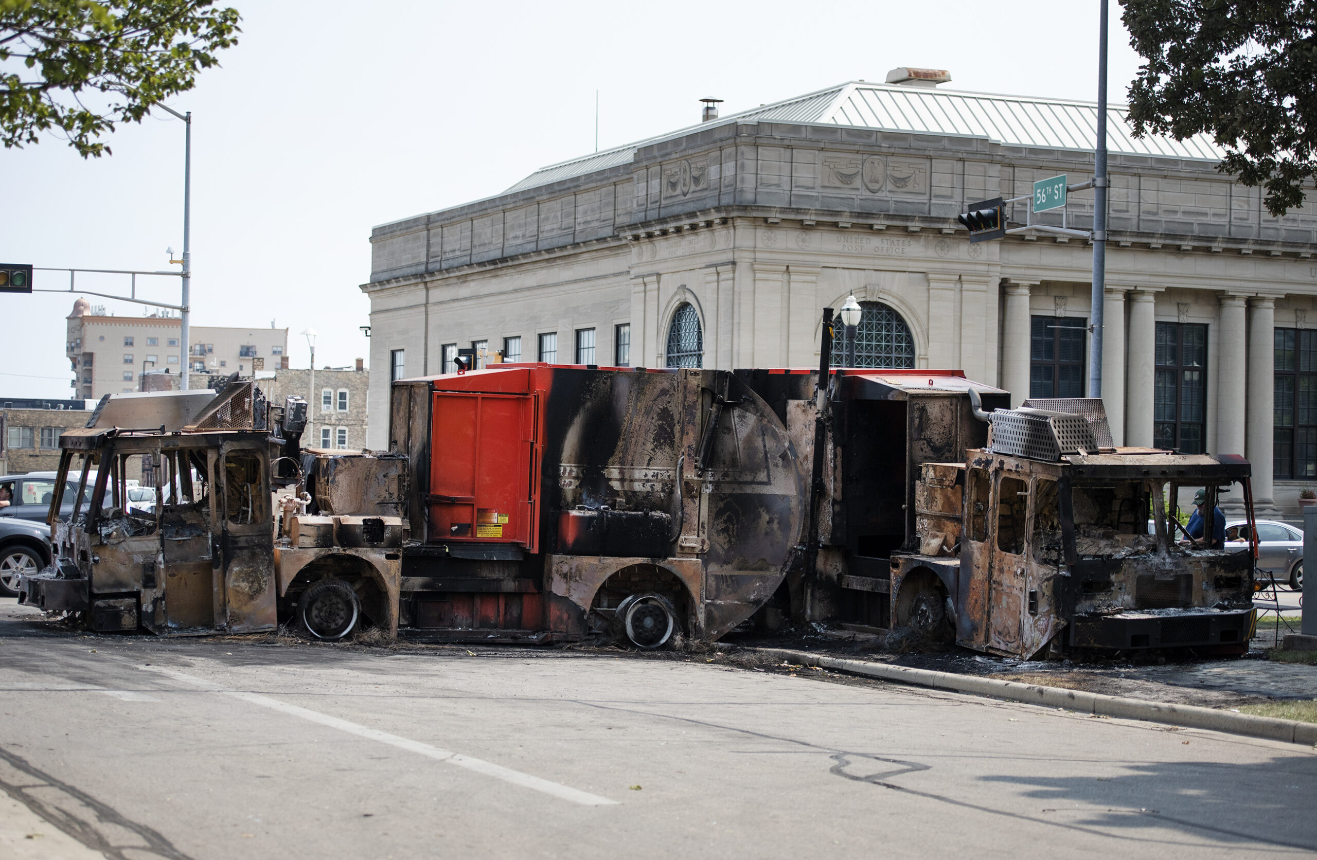 large burned up trucks block the road