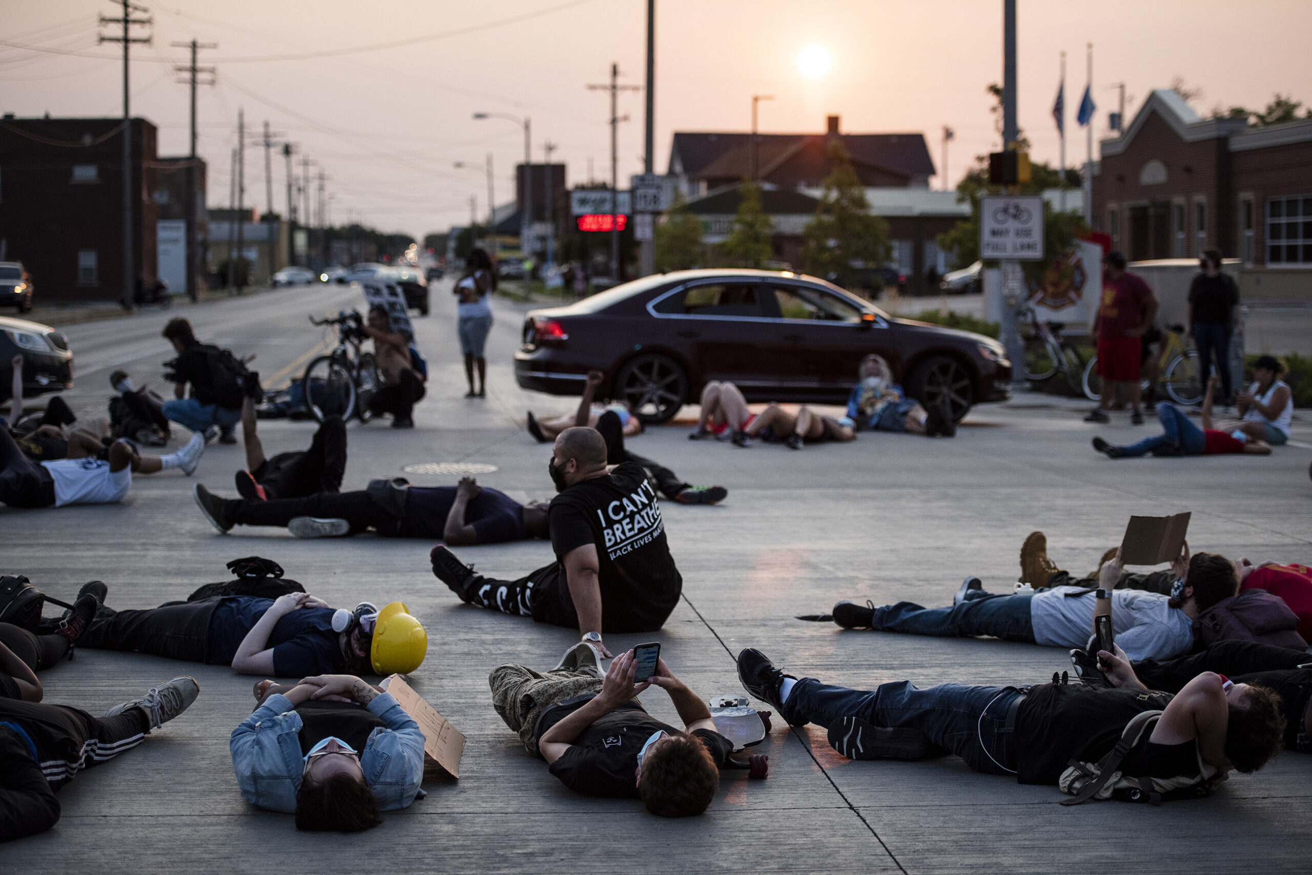 Protesters lie in the middle of the road