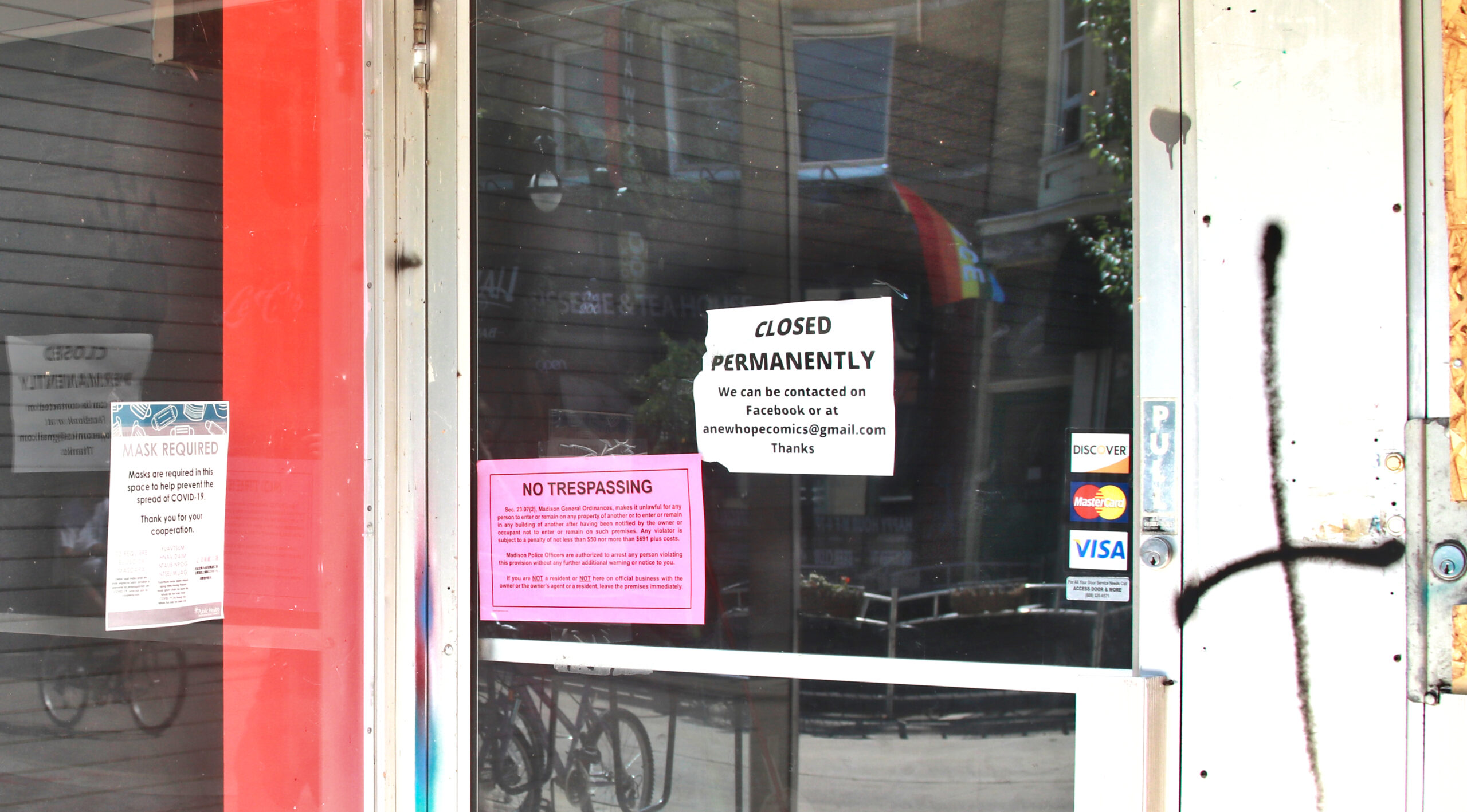A sign on a Madison store announce its permanent closure due to COVID-19