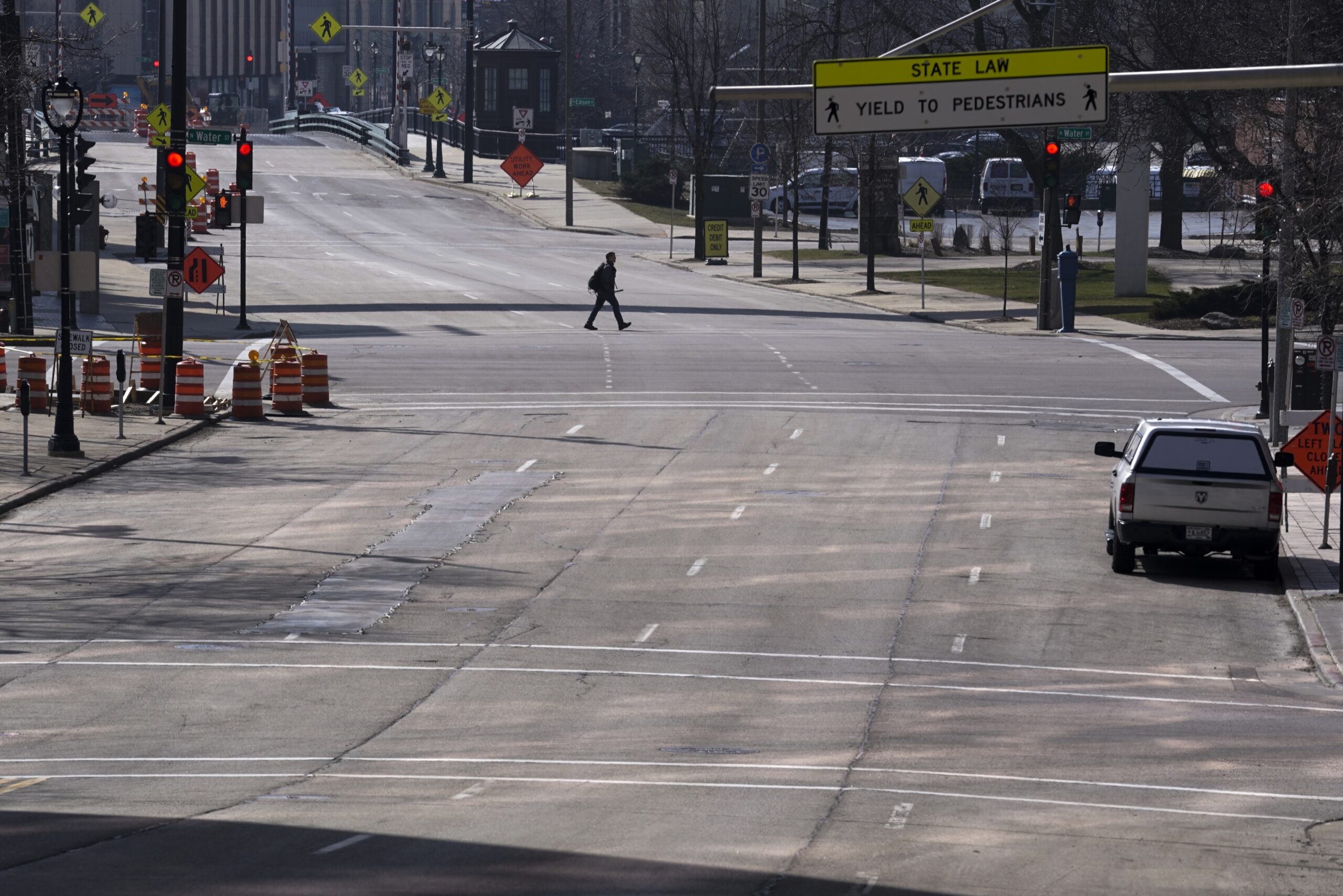 A lone pedestrian walking across a normally busy Milwaukee Street