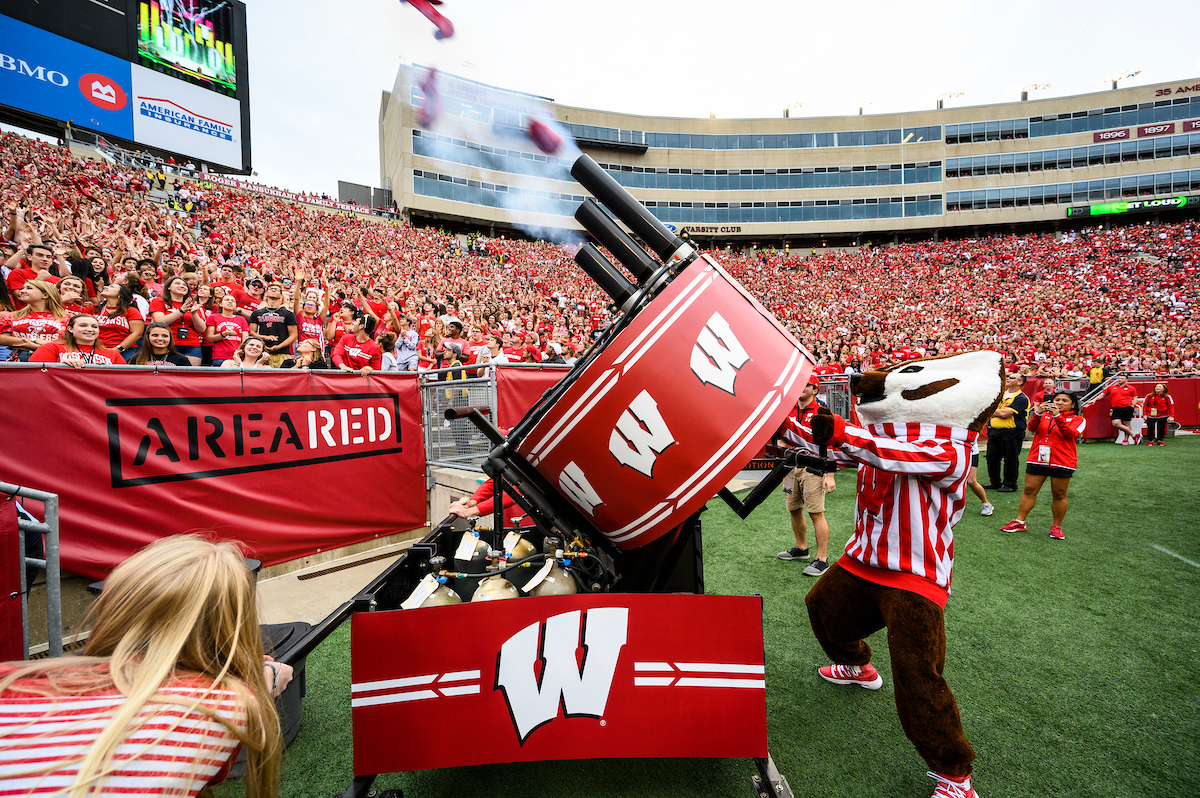 UW-Madison mascot Bucky Badger uses an air-pressurized cannon to fire free t-shirts.
