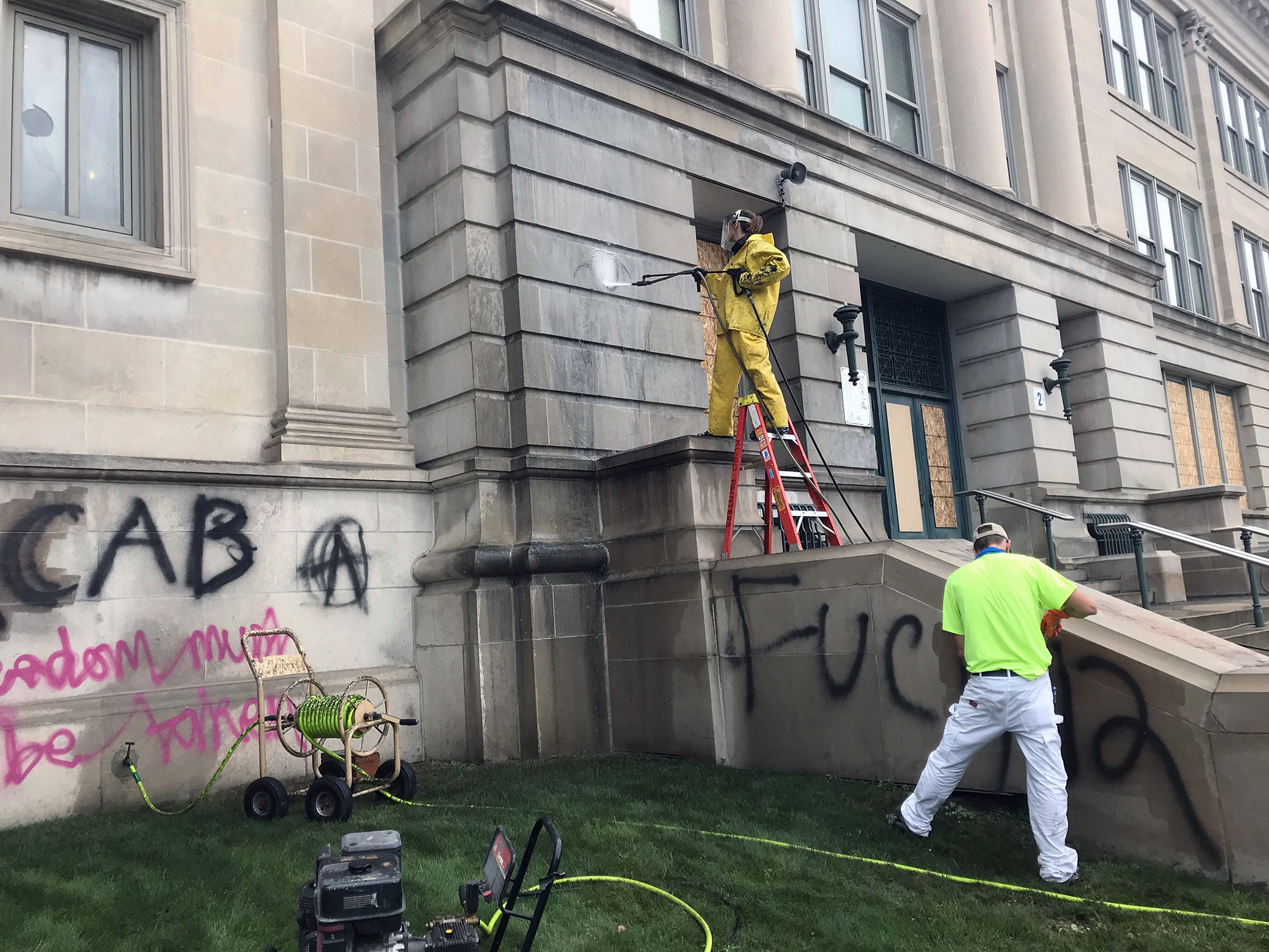 Workers clean off graffiti