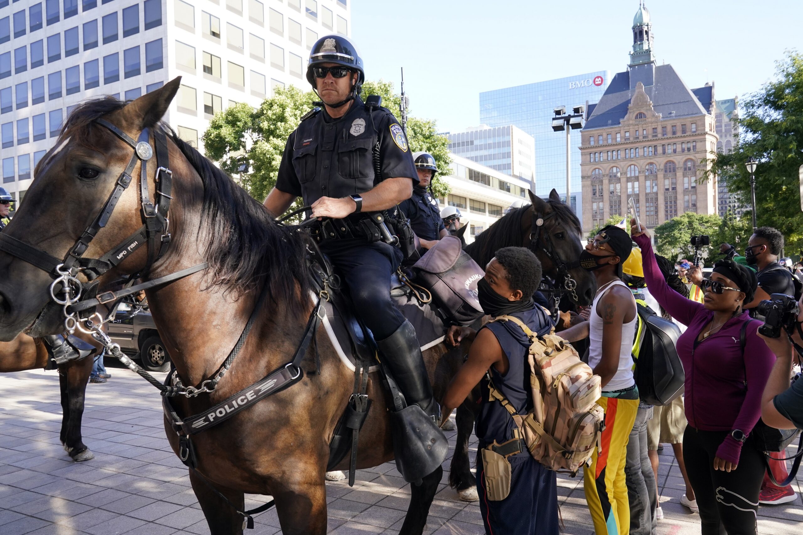 Police officers block protesters at the 2020 Democratic National Convention in Milwaukee.