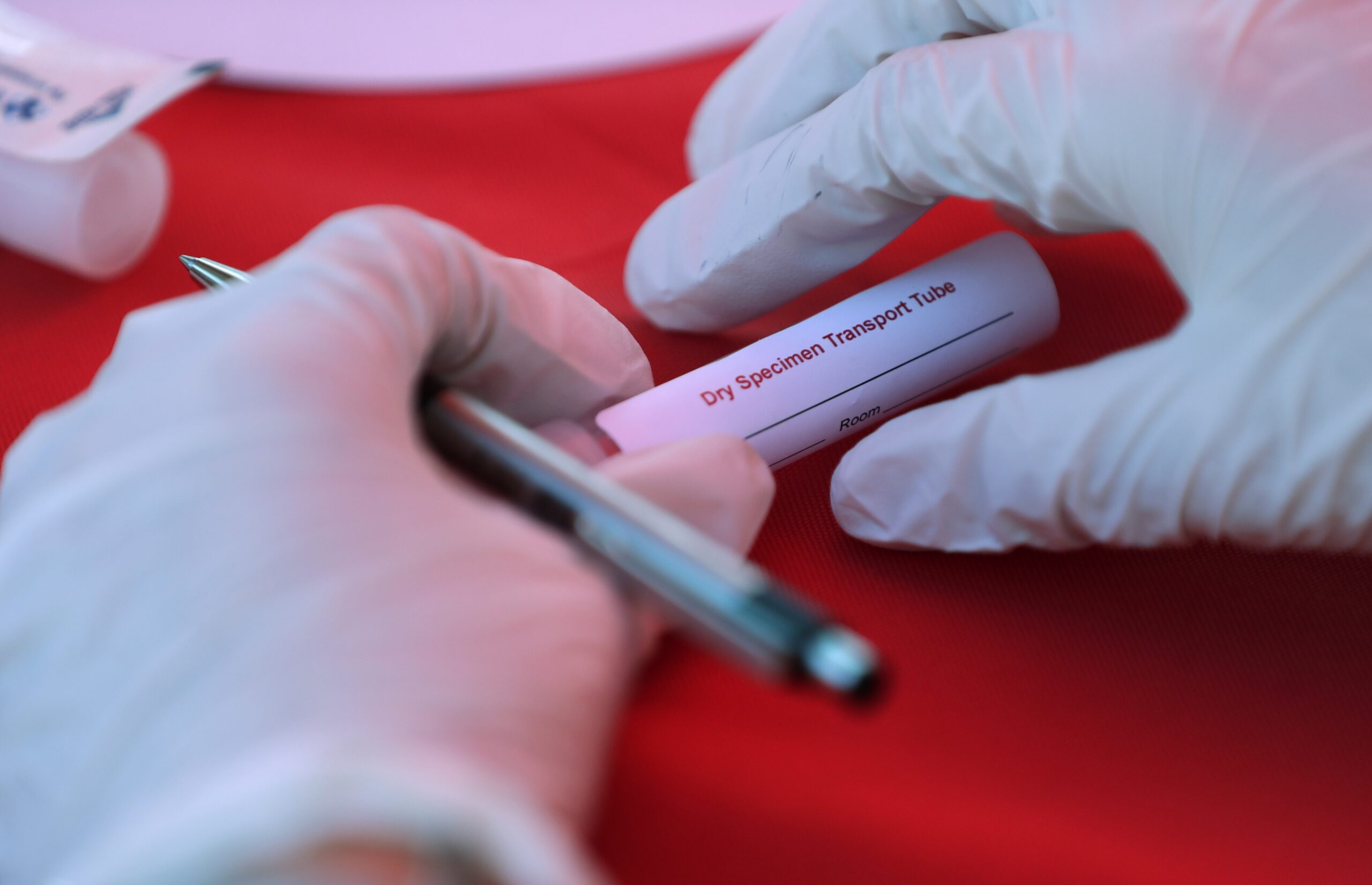 A worker prepares a collection tube during COVID-19 tests for first responders.