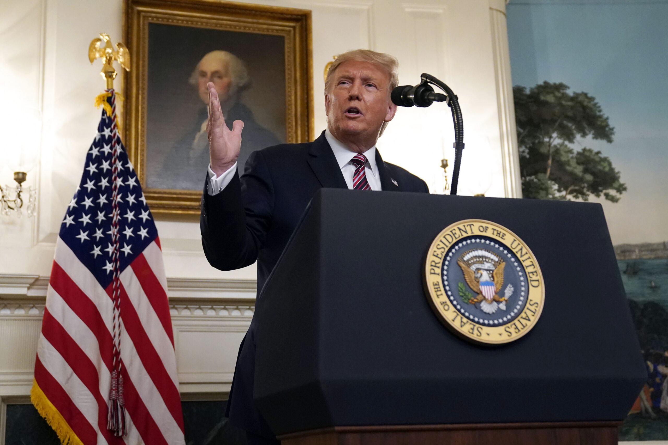 President Donald Trump speaks at a podium