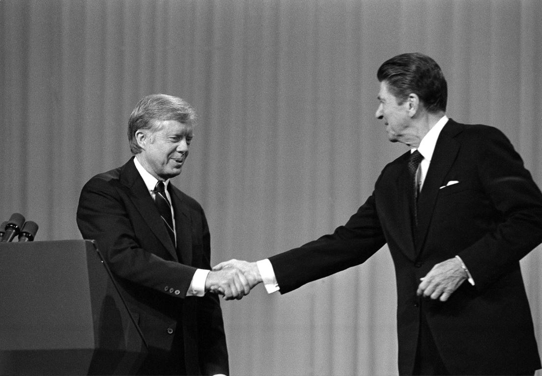 Jimmy Carter shakes hands with Ronald Reagan after debating in 1980