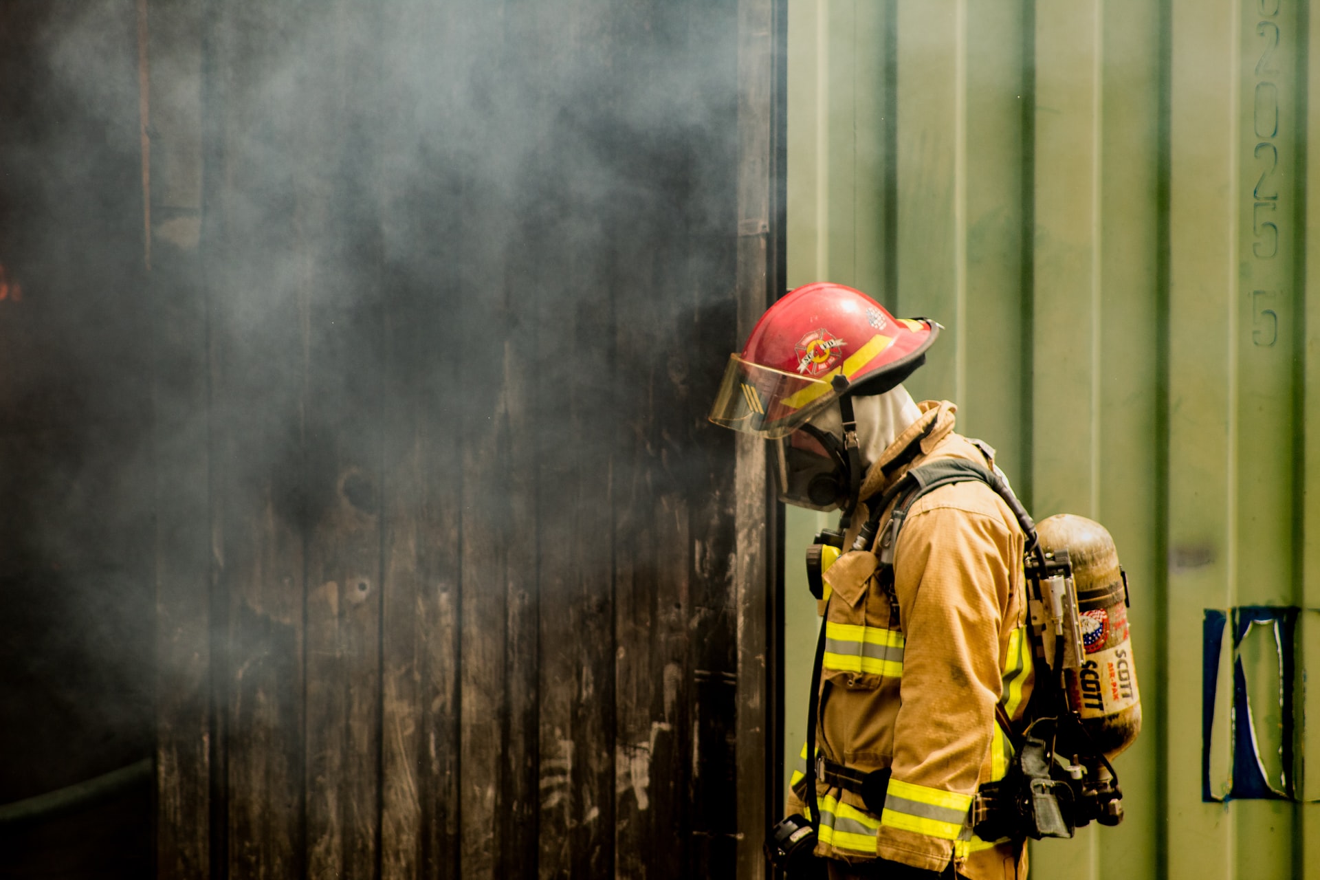 A firefighter gazes at a fire