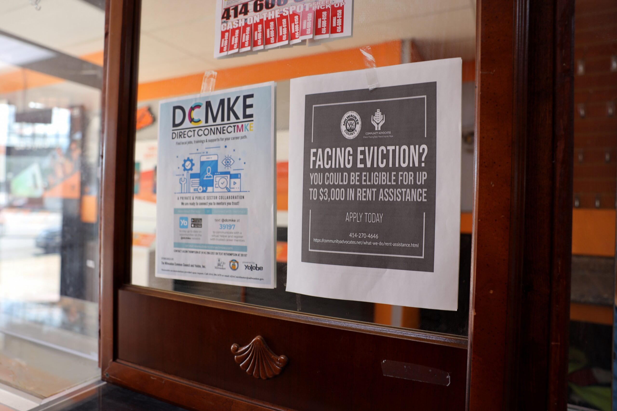 A sign inside a Boost Mobile store on Milwaukee’s Atkinson Avenue about housing assistance