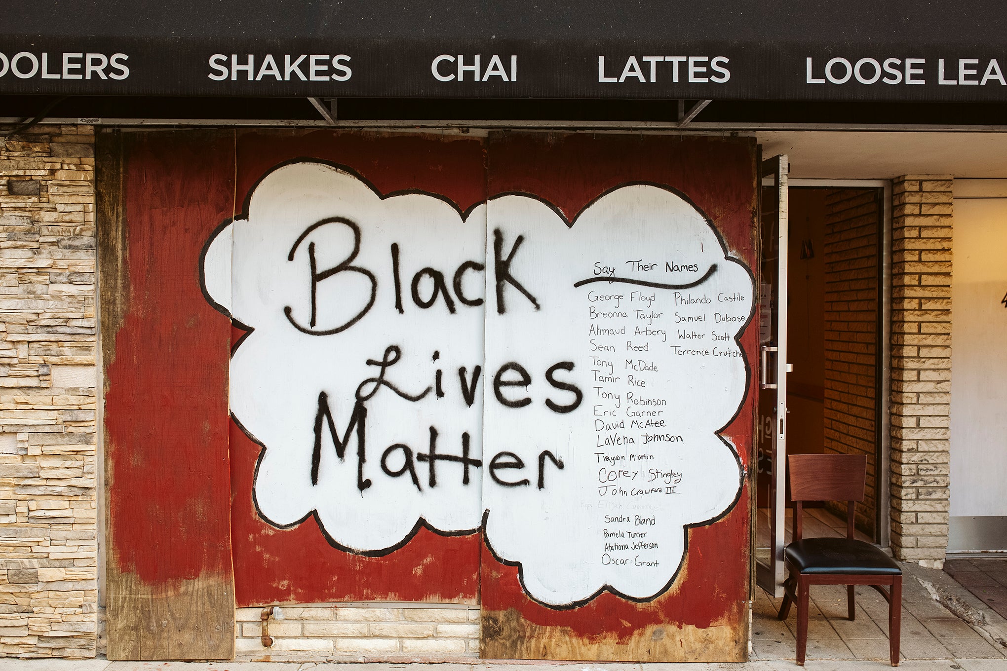 Artwork is displayed on boarded up store windows on State Street in downtown Madison