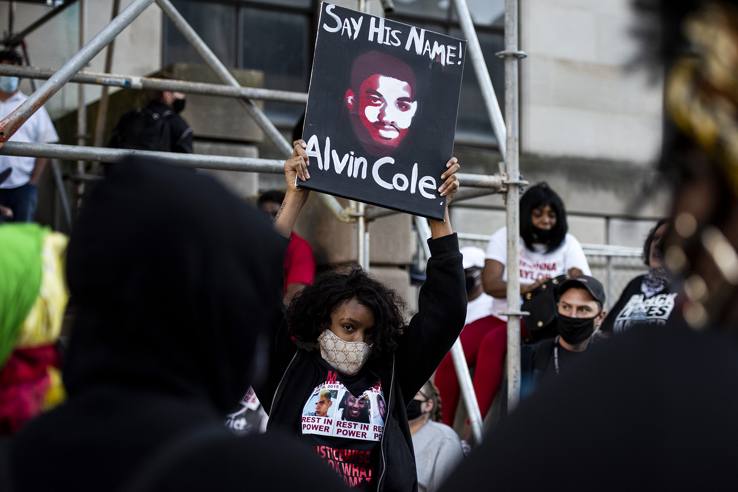 a woman holds a sign that says 