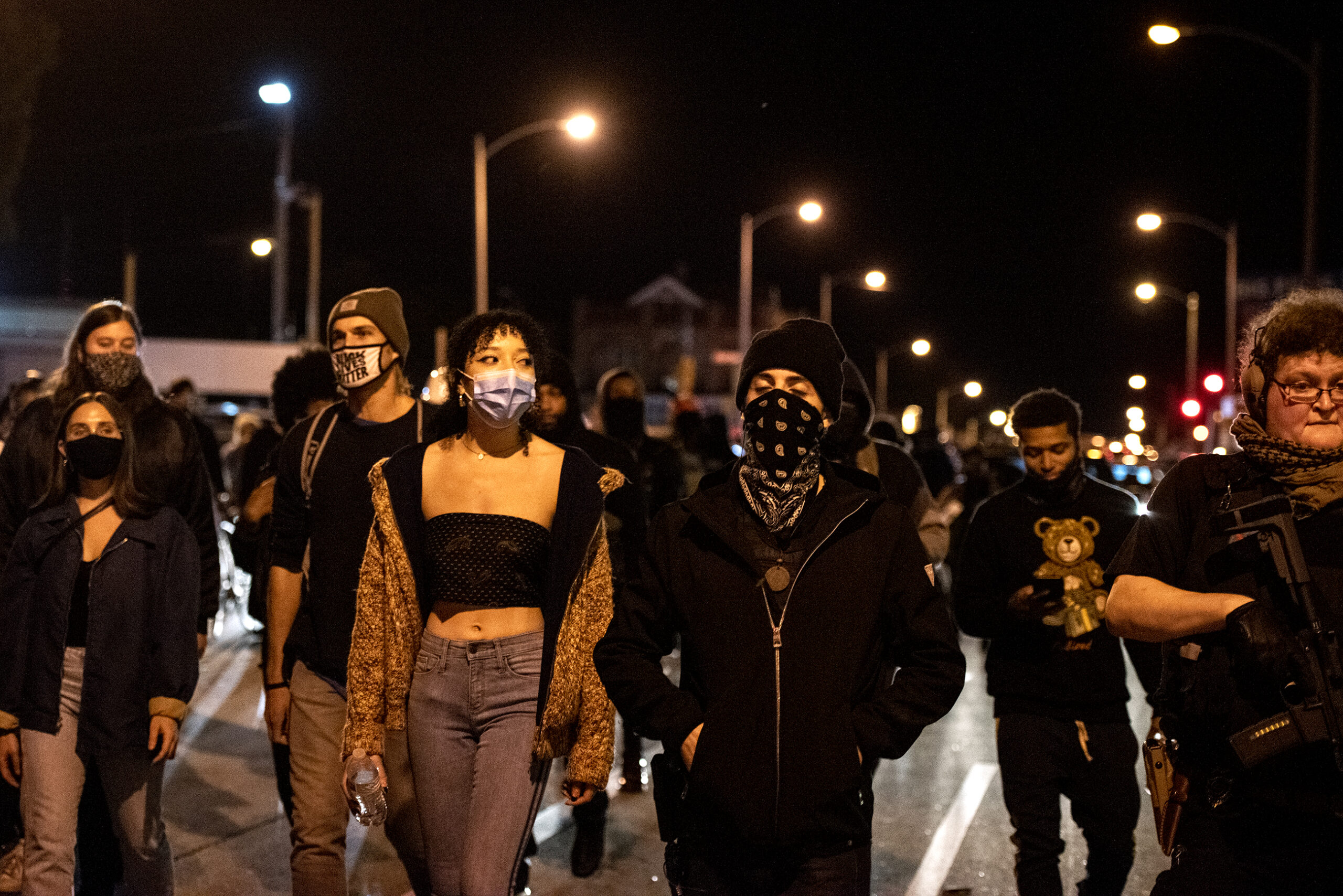 Protesters march in the street at night