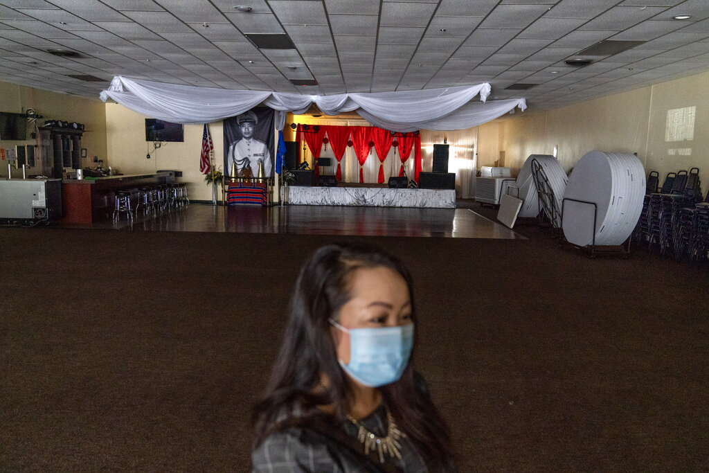 Businesswoman and city council member Maiyoua Thao stands in the virus-shuttered banquet hall in Appleton