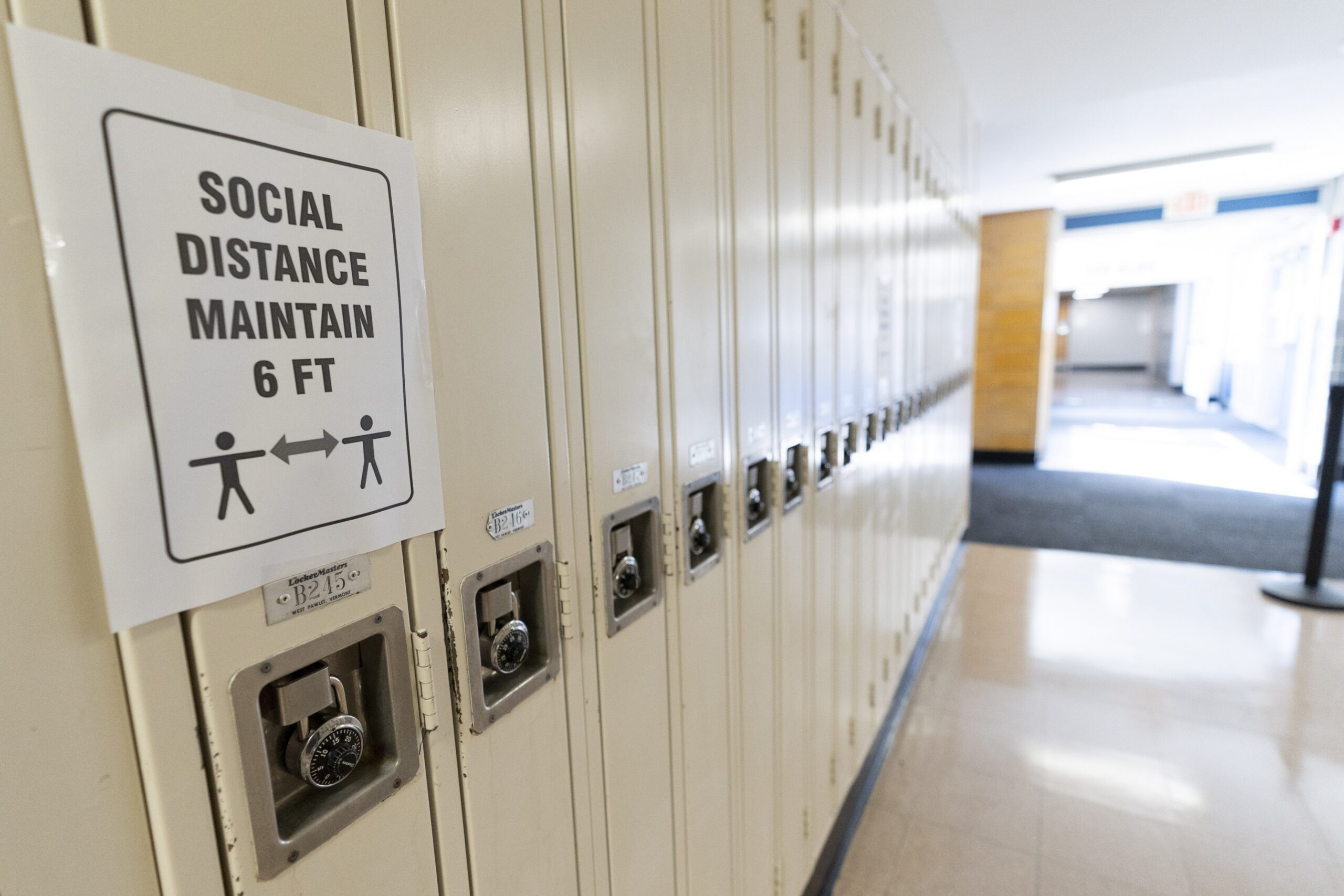 A social distancing sign is hung on a locker in Baldwin, N.Y.