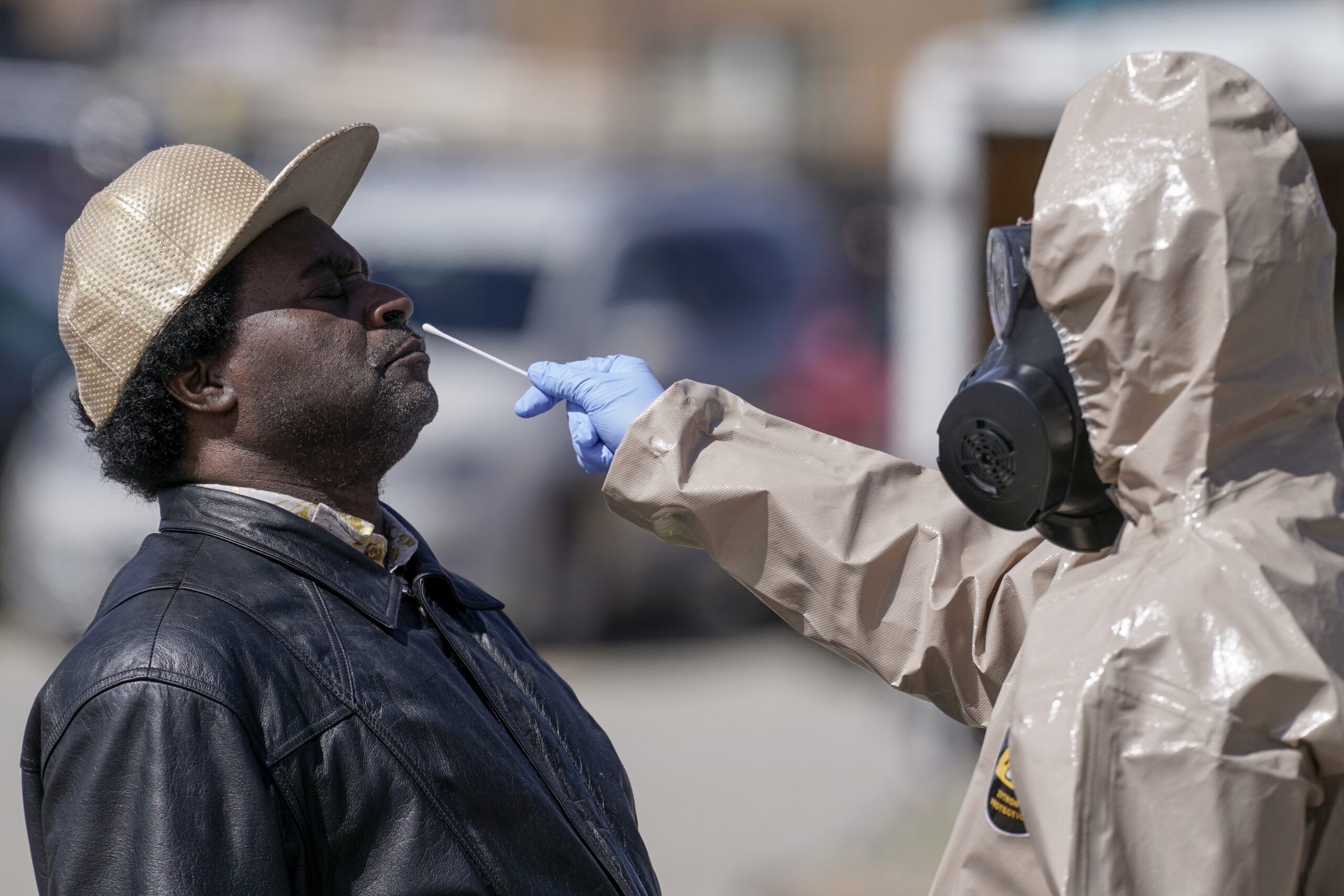Wisconsin National Guard members administer COVID-19 tests in a parking lot in Milwaukee.