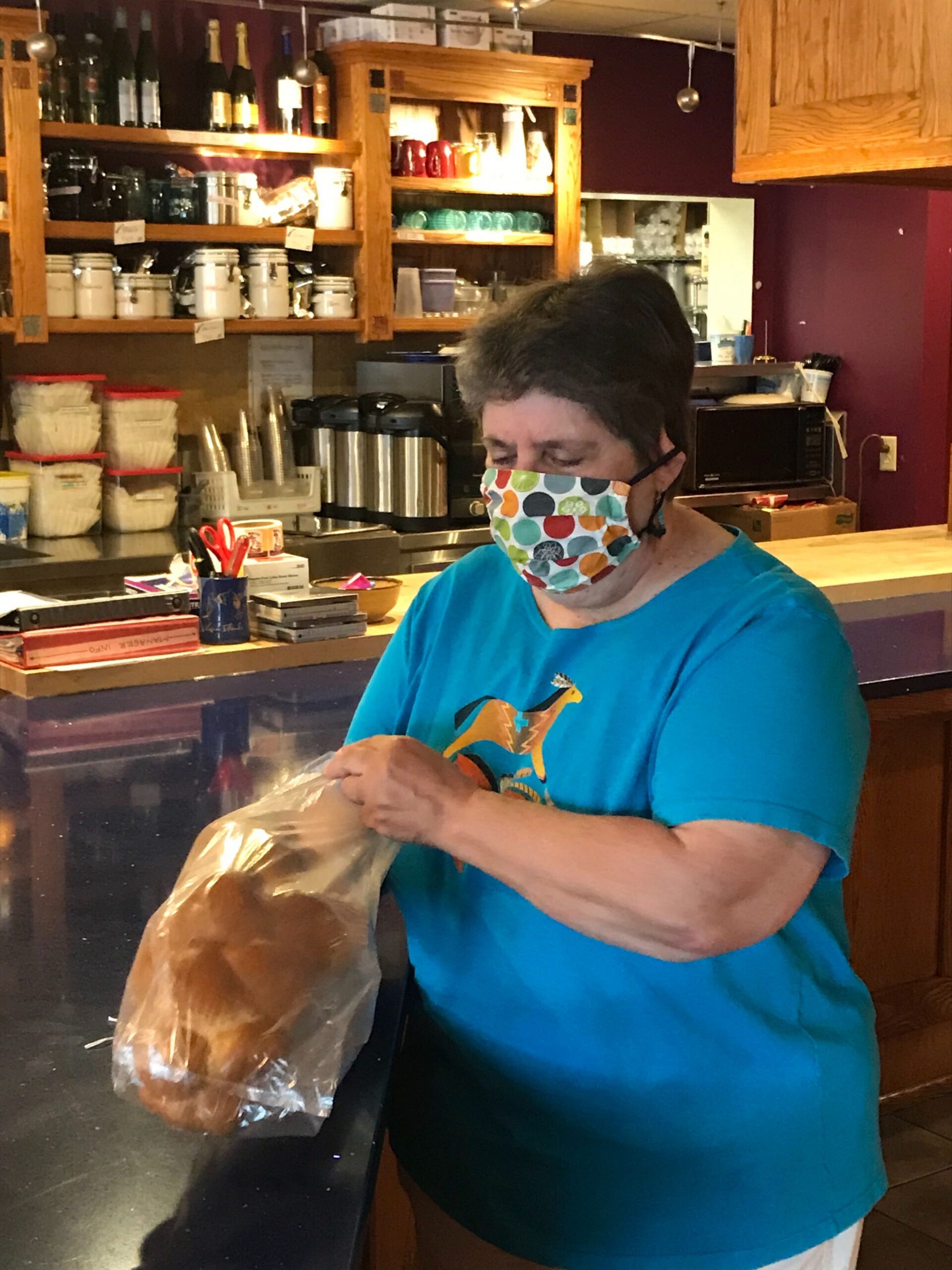 Barb Pratzel bags bread at Manna Cafe.