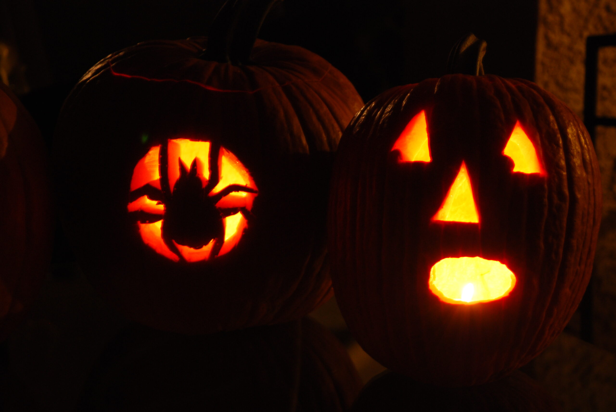 Spider and Frightened Face Carved Into Pumpkins